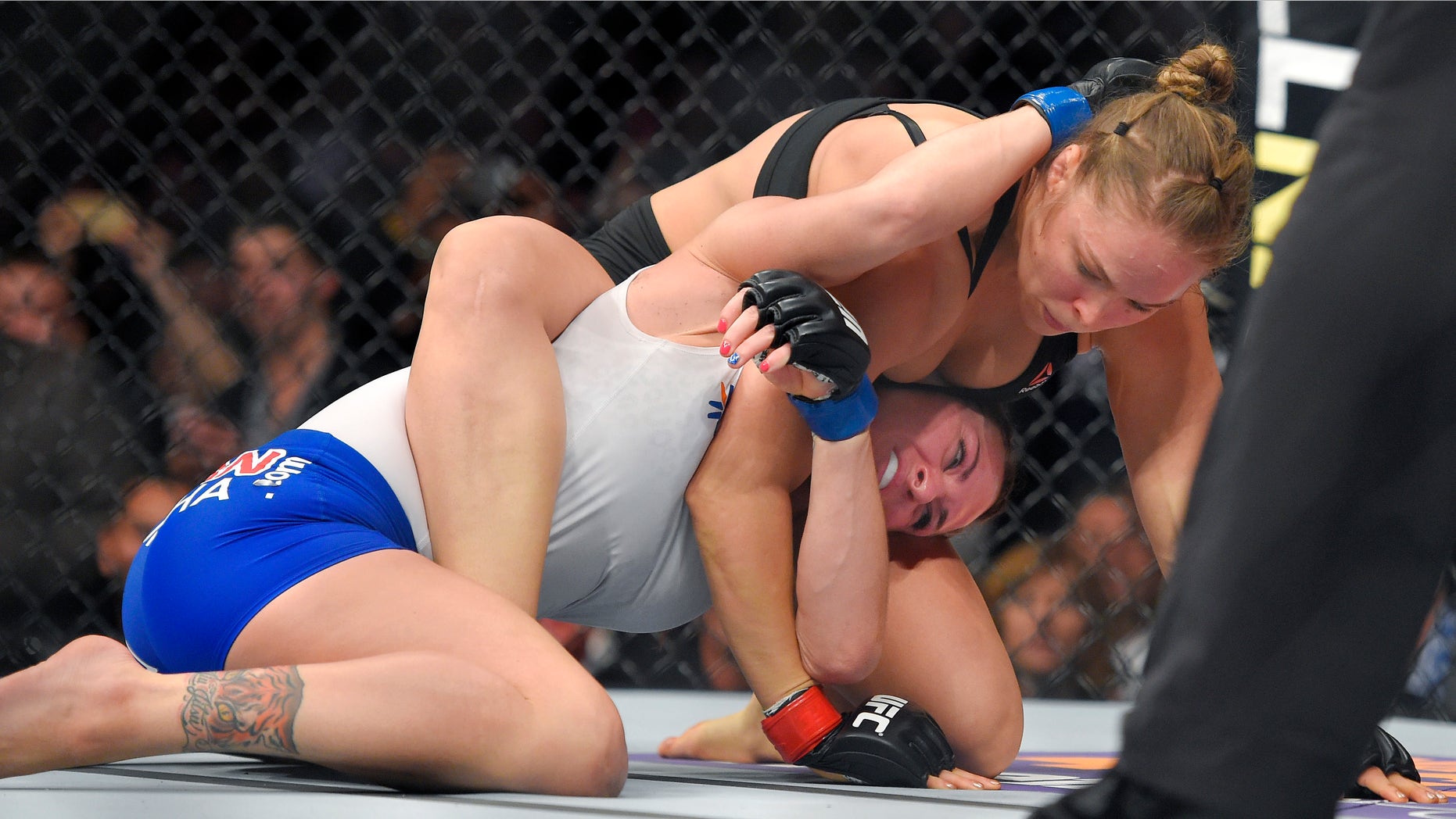 Ronda Rousey, right, grapples with Cat Zingano during a UFC 184 mixed martial arts bantamweight title bout, Saturday, Feb. 28, 2015, in Los Angeles. Rousey won after Zingano tapped out 14 seconds into the bout. (AP Photo/Mark J. Terrill)