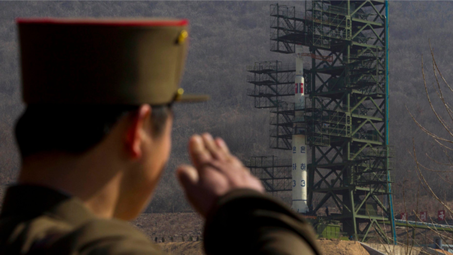 April 8, 2012: In this file photo, a North Korean soldier salutes in front of the country's Unha-3 rocket at Sohae Satellite Station in Tongchang-ri, North Korea.