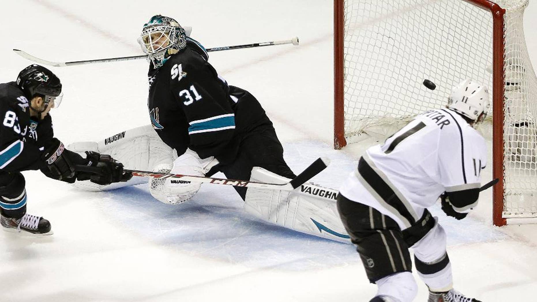 Los Angeles Kings center Anze Kopitar, of Yugoslavia, right, scores a goal past San Jose Sharks goalie Antti Niemi (31), of Finland, and left wing Matt Nieto (83) during the second period of Game 7 of an NHL hockey first-round playoff series in San Jose, Calif., Wednesday, April 30, 2014. (AP Photo)
