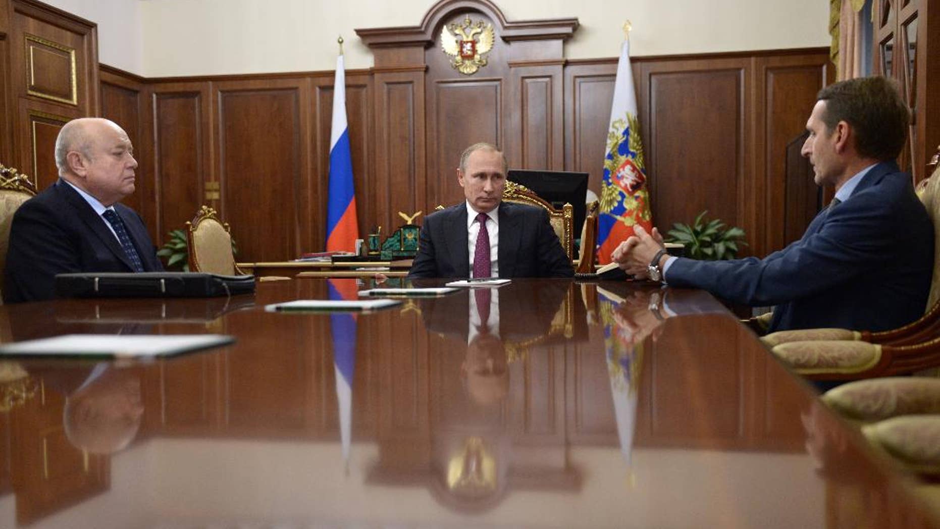From left, Foreign Intelligence Service head Mikhail Fradkov, Russian President Vladimir Putin, and parliament speaker Sergei Naryshkin meet in Moscow's Kremlin Russia, Thursday, Sept. 22, 2016. Putin offered Fradkov a post of a head of board of directors of the Russian railways and Naryshkin a post of a head of Foreign Intelligence Service. (Alexei Nikolsky/Sputnik, Kremlin Pool Photo via AP)