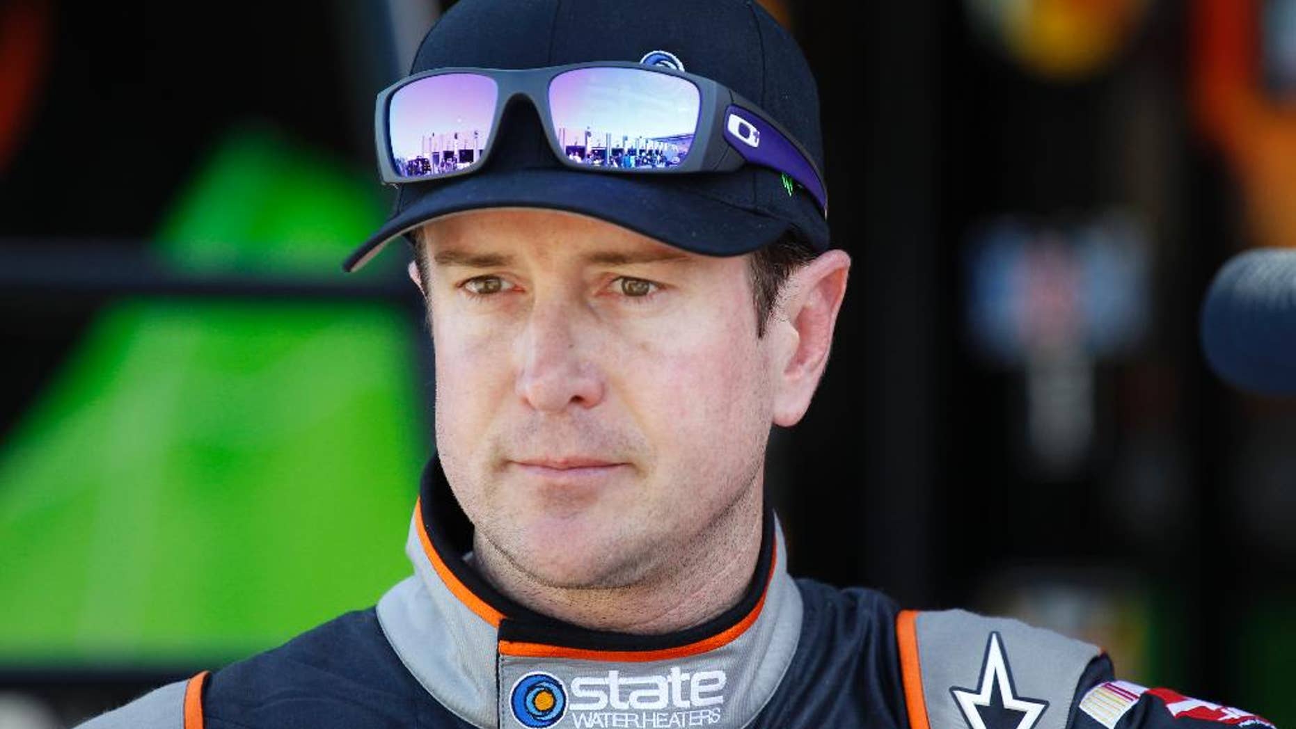 FILE - In this Oct. 9, 2014, file photo, Kurt Busch looks from the garage after practice for the NASCAR Bank of America Sprint Cup series auto race at Charlotte Motor Speedway in Concord, N.C. Delaware prosecutors said, Thursday, March 5, 2015, that they will not file criminal charges against Busch following allegations of domestic violence against his ex-girlfriend. (AP Photo/Terry Renna, File)
