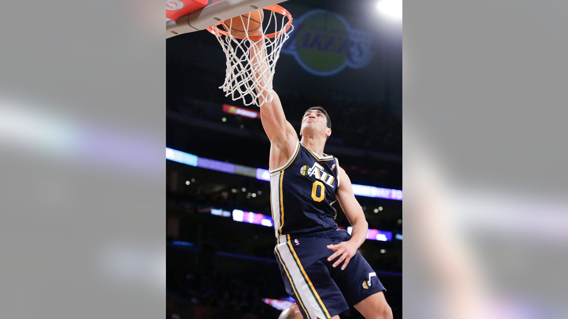 Utah Jazz center Enes Kanter dunks against the Los Angeles Lakers during the first half of a NBA preseason basketball game in Los Angeles, Tuesday, Oct. 22, 2013. (AP Photo/Chris Carlson)
