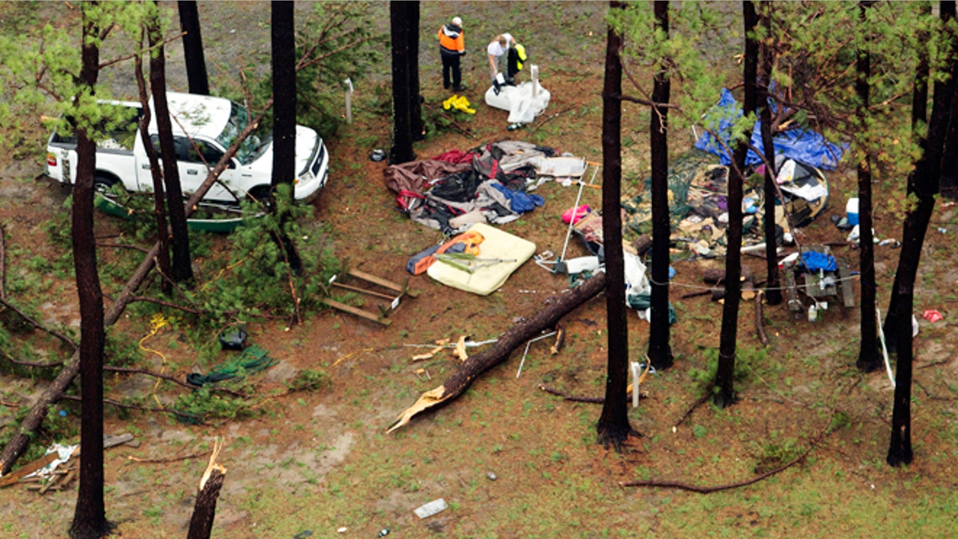 In this aerial photo people inspect damage at Cherrystone Family Camping & RV Resort in Northampton County, Thursday, July 24, 2014, near Cheriton, Va., after a severe storm swept through the area. Softball-sized hail and rain toppled dozens of trees and flipped recreational vehicles at the campground Thursday, killing two people and injuring more than two dozen, officials said. (AP Photo/The Virginian-Pilot, L. Todd Spencer) MAGS OUT