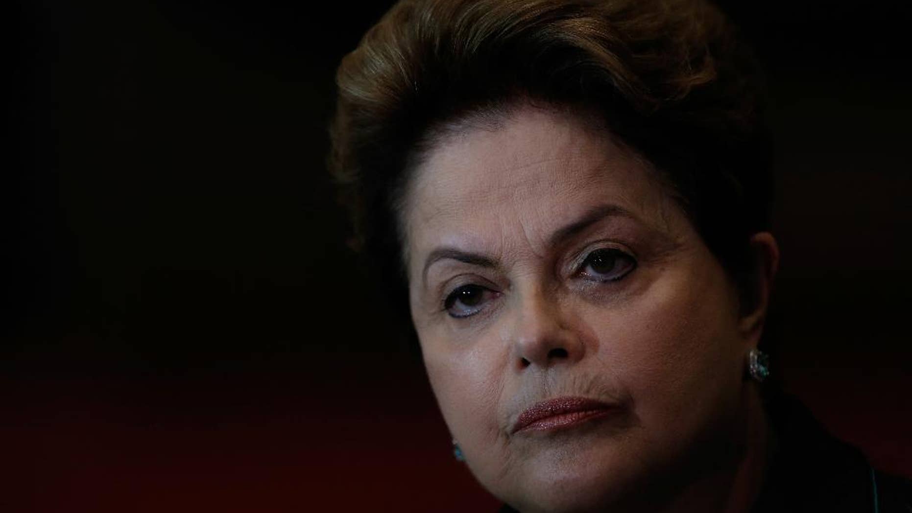 Brazil's President Dilma Rousseff, who is running for reelection with the Workers Party, PT, listens to a question during a campaign news conference at the Alvorada Palace, in Brasilia, Brazil, Monday, Oct. 6, 2014. Official results showed Sunday that President Dilma Rousseff will face challenger Aecio Neves in a second-round vote in Brazil's most unpredictable presidential election since the nation's return to democracy nearly three decades ago. (AP Photo/Eraldo Peres)