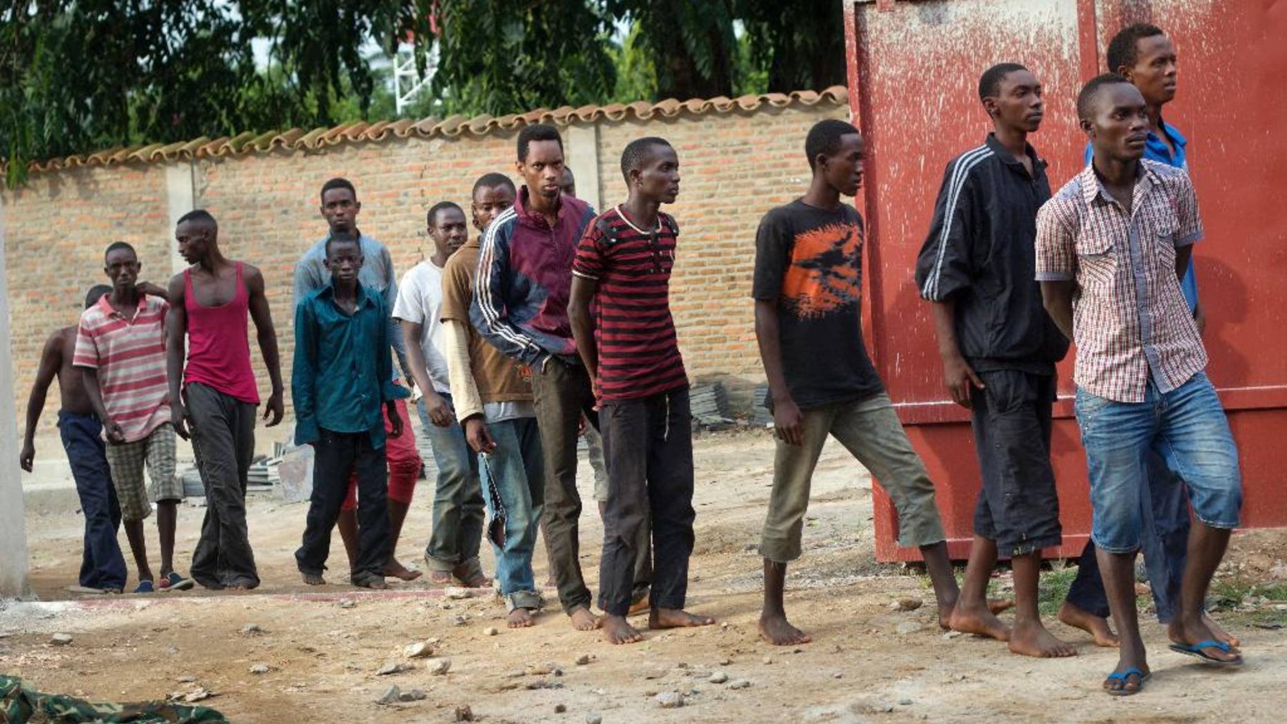 FILE - In this Saturday, Dec. 12, 2015 file photo, men captured by the security forces, who were said by them to have been involved in attacks on military targets but which could not be independently verified, are paraded during a press conference at the country's intelligence service headquarters in the capital Bujumbura, Burundi. An online network of Burundian activists is trying to bring international attention to what it says are rising incidents of people being disappeared by local police and intelligence agents. (AP Photo/Melanie Gouby, File)
