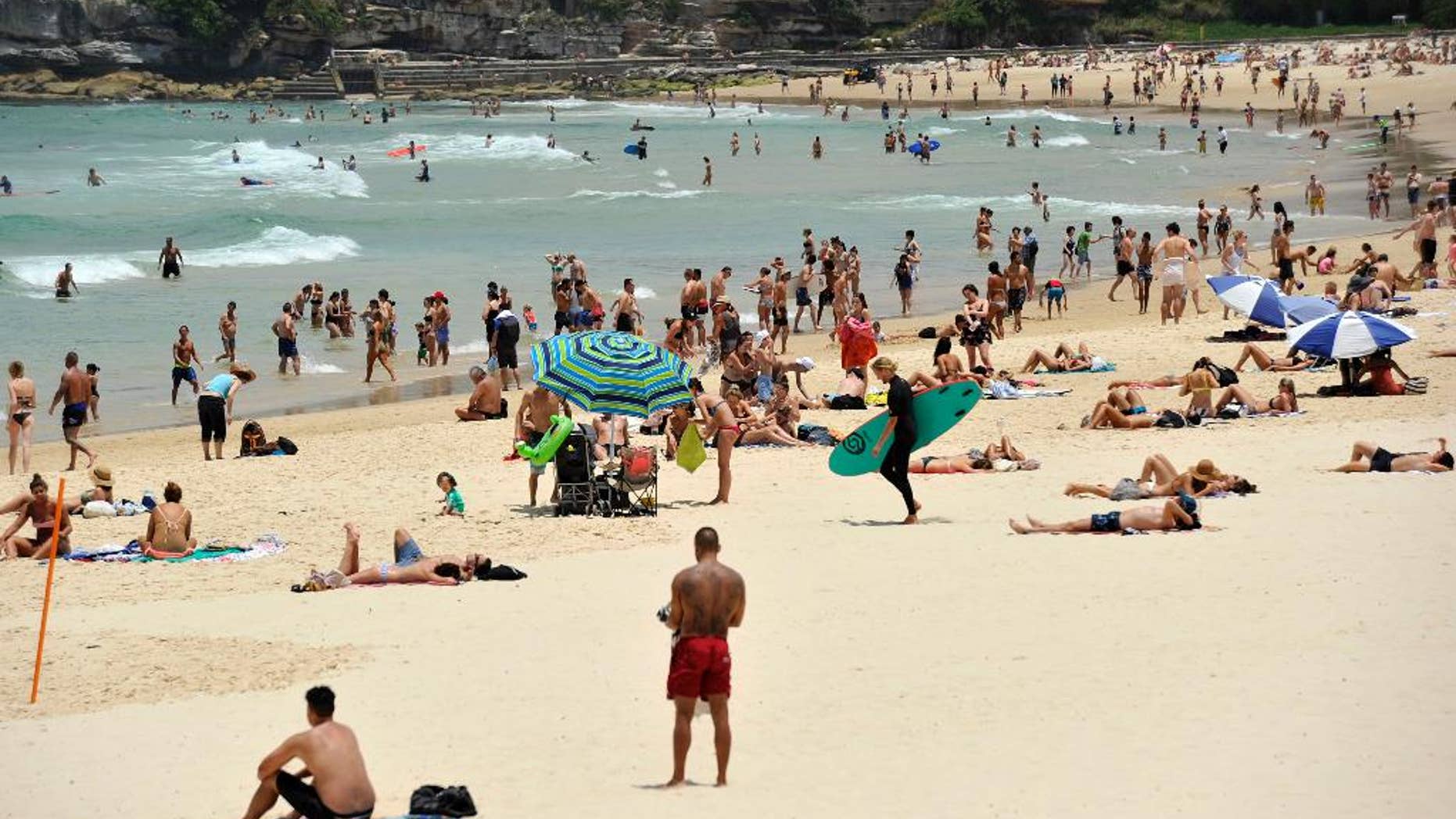 In this Tuesday, Dec. 13, 2016 photo, people gather on the sand at Bondi Beach in Sydney, Australia. Sydney residents sweltered through the city's second hottest night on record and its hottest December night in 148 years, with many cooling off at beaches long after dark. A minimum of 27.1 degrees Celsius (80.8 degrees Fahrenheit) was recorded in Australia's largest city early Wednesday, Australian Bureau of Meteorology forecaster Jordan Notara said. (Joel Carrett/AAP Image via AP)
