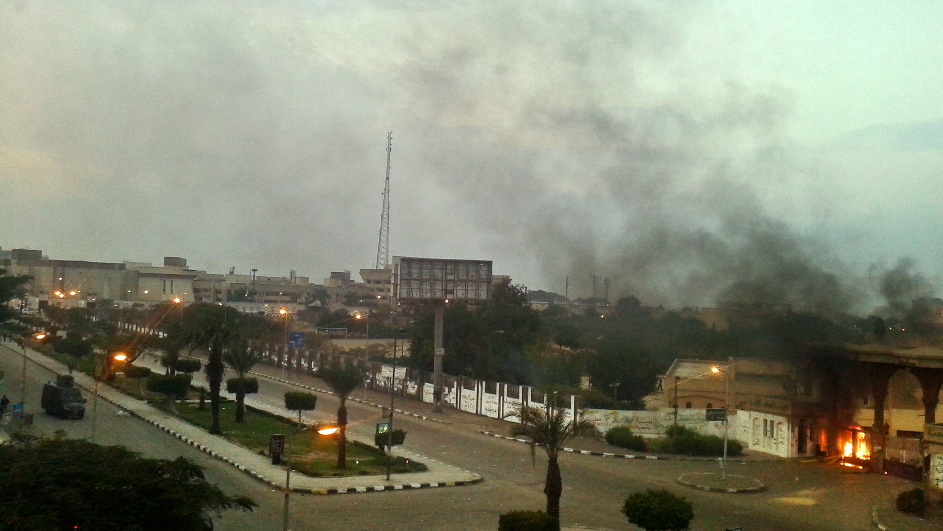 Smoke billows the air after at Al-Azhar University students had lit a fire at the dorm gates to lessen the impact of tear gas fired by police to disperse supporters of the country’s ousted Islamist president protesting at the dormitories of the Islamic university in Cairo, Egypt, Sunday Dec. 8, 2013. Students at Al-Azhar University hurled rocks at the police and tried to block traffic on a major thoroughfare outside the campus in eastern Cairo, a security official said. The official spoke on condition of anonymity because he was not authorized to speak to reporters. (AP Photo/Mohamed Hassan)