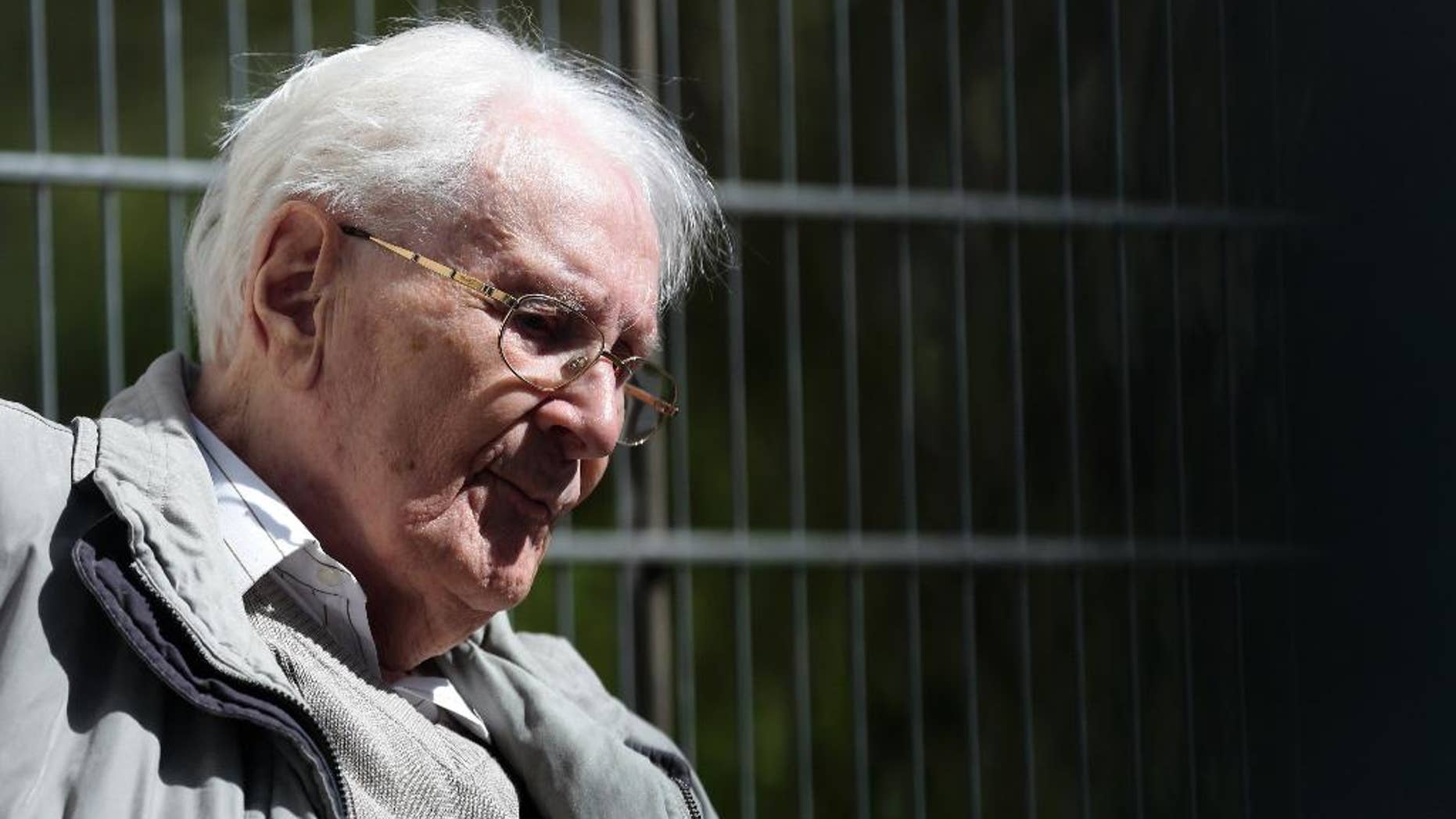 Former SS guard Oskar Groening sits in ths sun during the noon break of the trial against him in Lueneburg, northern Germany, Tuesday, April 21, 2015. 93-years-old Groening faces 300,000 counts of accessory to murder at the trial, which will test the argument that anyone who served as a guard at a Nazi death camp was complicit in what happened there. Groening said he bears a share of the moral guilt for atrocities at the camp, but told judges it is up to them to decide whether he deserves to be convicted as an accessory to murder. (AP Photo/Markus Schreiber)