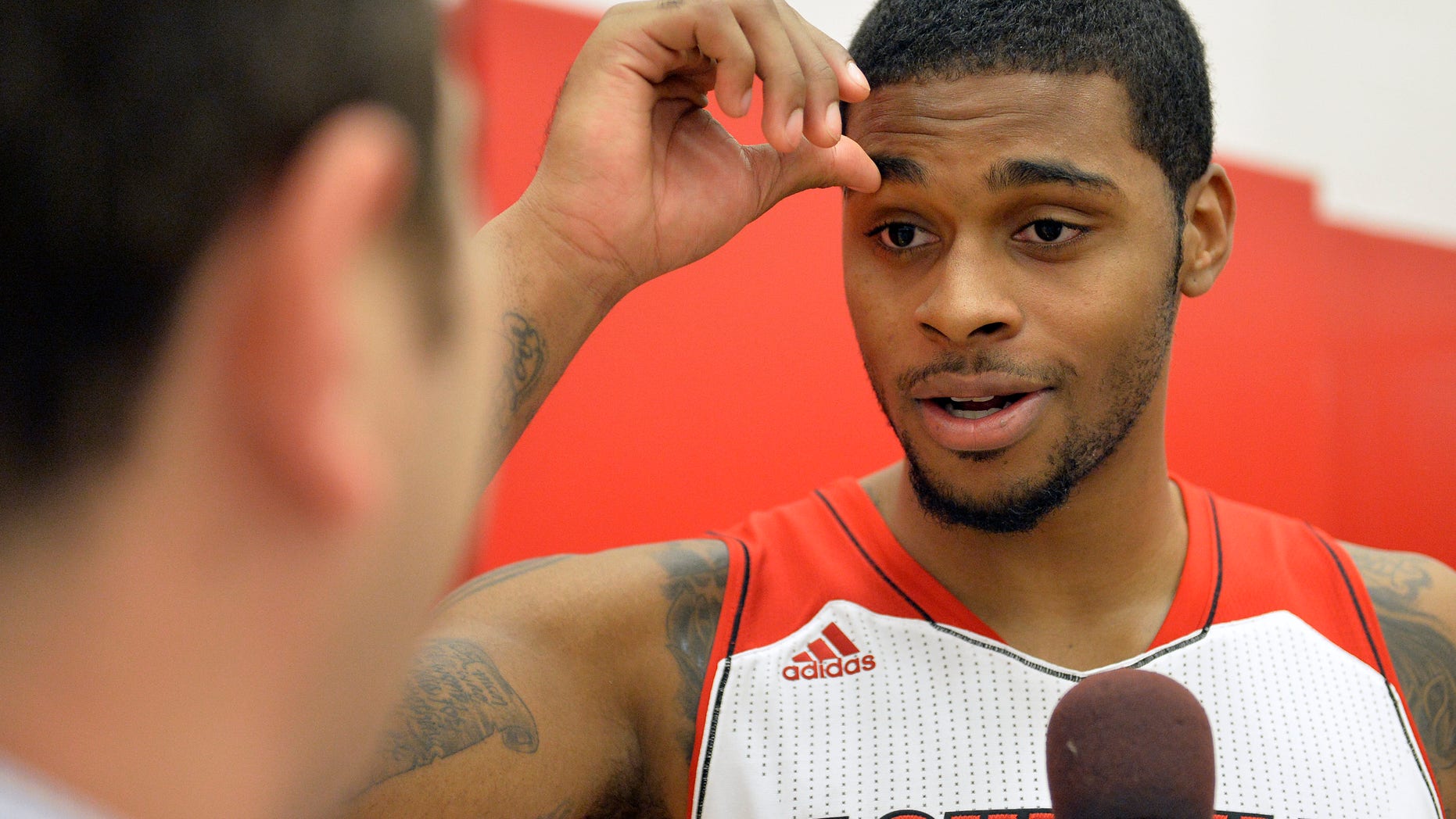 Louisville's Chane Behanan fields questions during NCAA college basketball media day, Saturday, Oct. 12, 2013, in Louisville, Ky. (AP Photo/Timothy D. Easley)