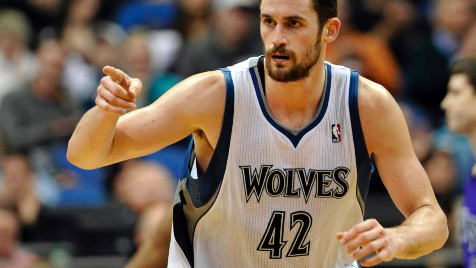 FILE - In this Jan. 16, 2012, file photo, Minnesota Timberwolves' Kevin Love reacts during the second half of an NBA basketball game against the Sacramento Kings in Minneapolis. The Timberwolves, Cleveland Cavaliers and Philadelphia 76ers completed a blockbuster trade sending Love to team up with LeBron James in Cleveland for 2014 No. 1 draft pick Andrew Wiggins on Saturday, Aug. 23, 2014, a person familiar with the trade said. The Timberwolves are getting Wiggins and former top pick Anthony Bennett from Cleveland and veteran forward Thaddeus Young from Philadelphia. The 76ers get a 2015 first-round draft choice from Cleveland, and guard Alexey Shved and forward Luc Mbah a Moute from Minnesota. (AP Photo/ Jim Mone, File)