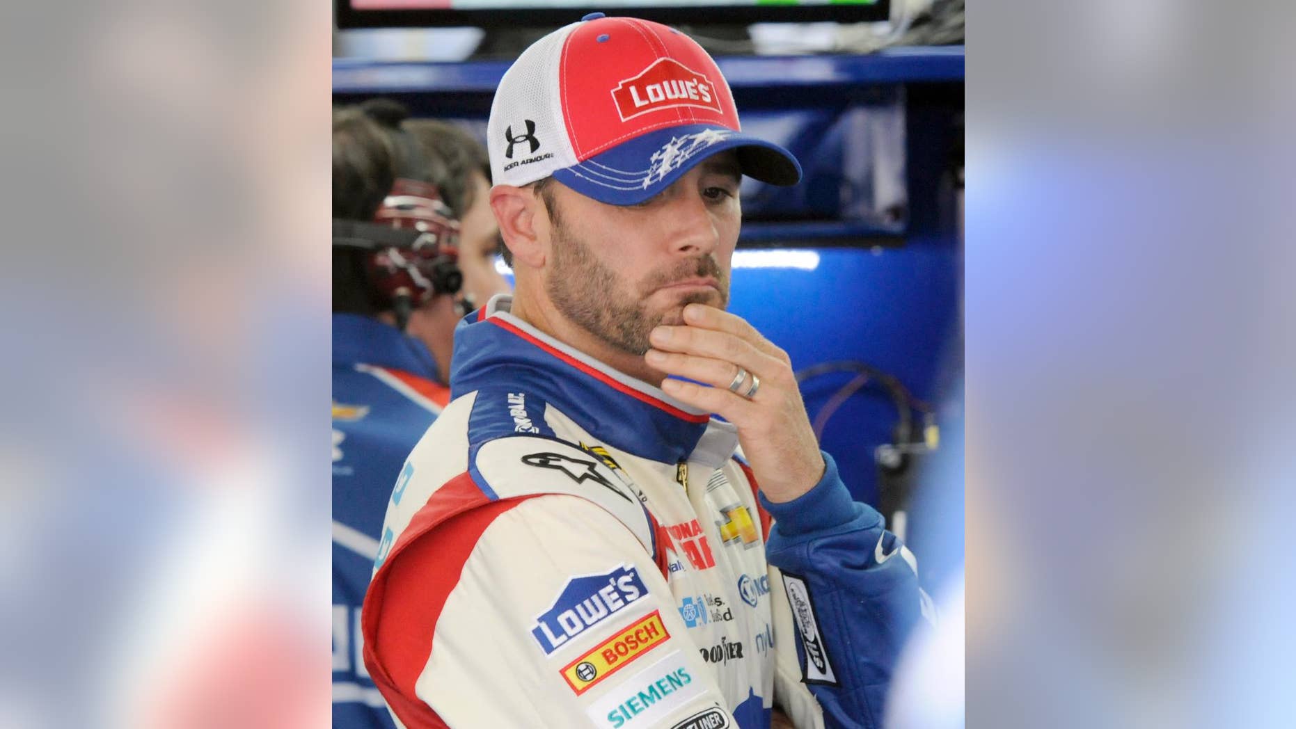 Driver Jimmie Johnson waits by his car before practice for Saturday's NASCAR Sprint Cup series auto race at Charlotte Motor Speedway in Concord, N.C., Friday, May 16, 2014. (AP Photo/Mike McCarn)