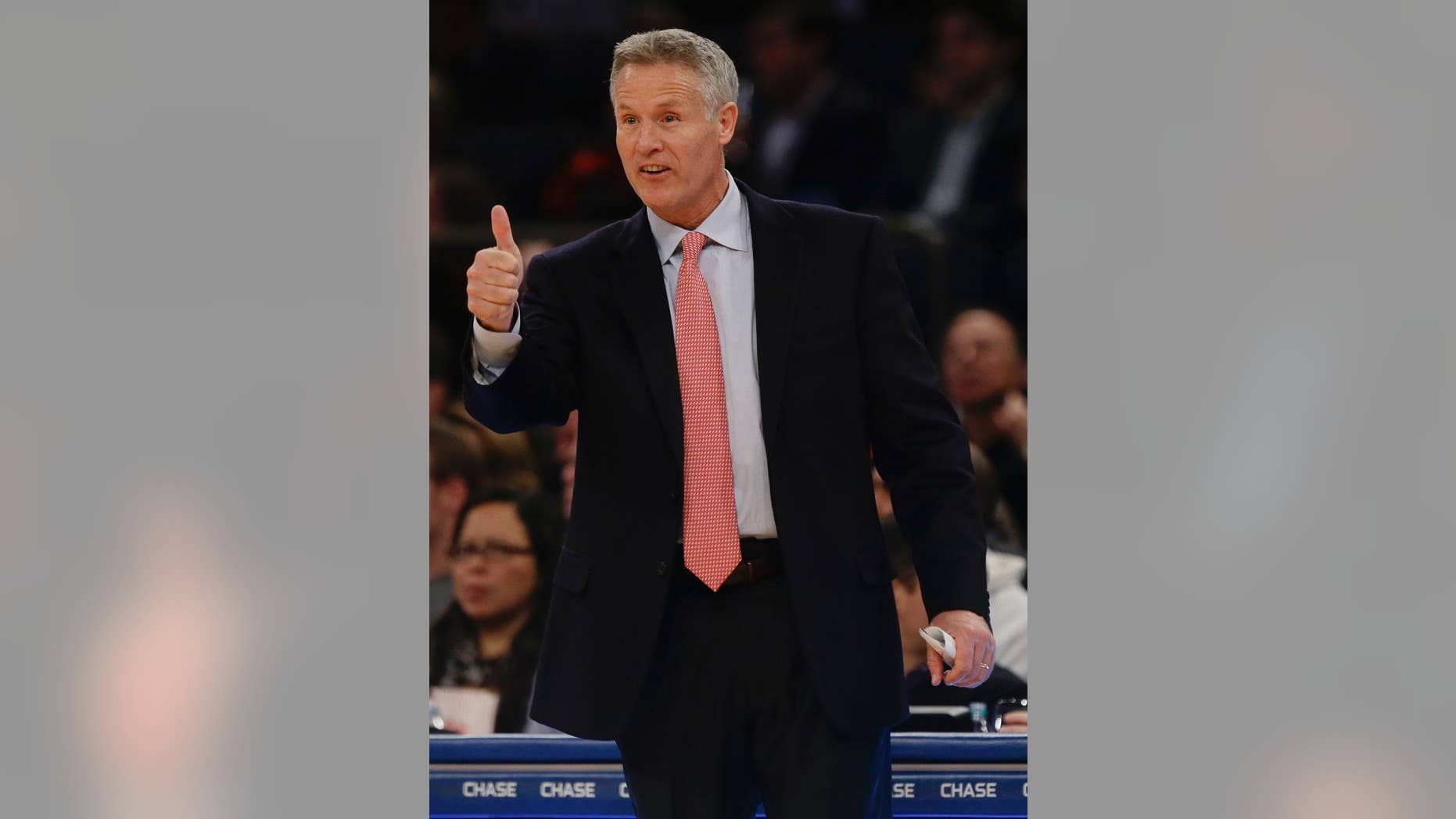Philadelphia 76ers' head coach Brett Brown gestures to a player during the first half of an NBA basketball game against the New York Knicks, Saturday, Nov. 22, 2014, in New York. (AP Photo/Frank Franklin II)