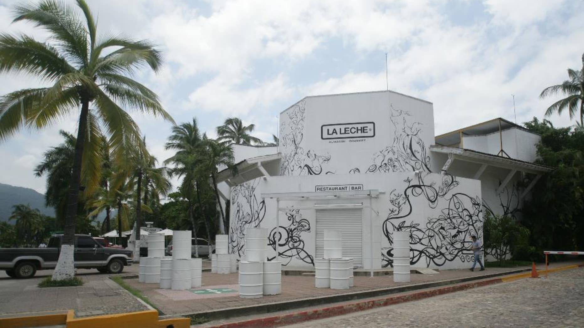 The entrance of the restaurant "La Leche" stands closed after armed men abducted as many as 16 people who were dining in the upscale restaurant in Puerto Vallarta, Mexico, Monday, Aug. 15, 2016. Jalisco state prosecutor Eduardo Almaguer said in a news conference that preliminary results of the investigation indicate that all involved, kidnappers and kidnapped, were members of criminal organizations. (AP Photo/David Diaz)