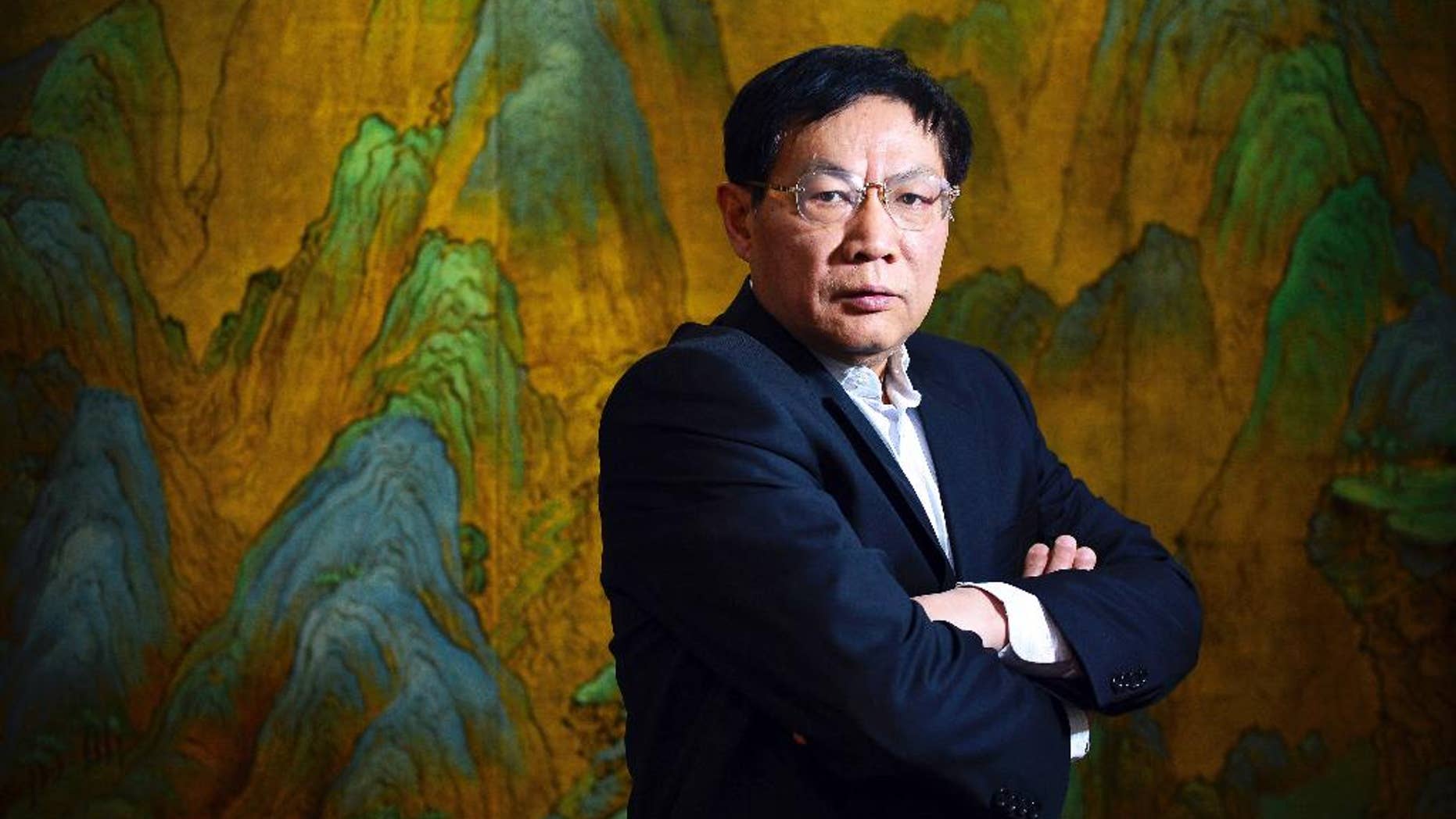 FILE- In this file photo taken Dec. 3, 2012, Chinese real estate mogul Ren Zhiqiang poses for photos in his office in Beijing, China. China's Communist Party has punished the property mogul and outspoken government critic by placing him on probation for a year after he criticized state media for pledging absolute loyalty to the party. A Beijing district branch of the party handed down the punishment to property tycoon Ren Zhiqiang, saying his "erroneous remarks" online "seriously violated the party's political discipline," according to the local government's website in a posting Monday, May 2, 2016. (Color China Photo via AP, File) CHINA OUT