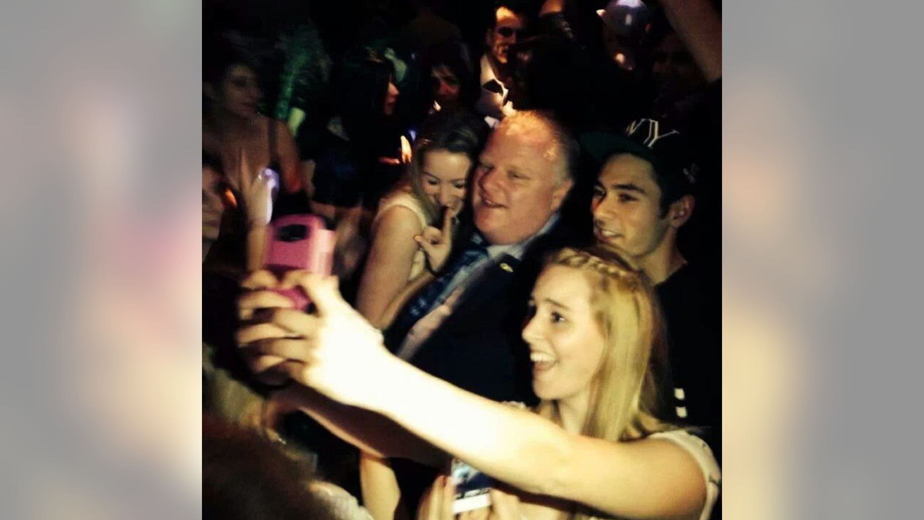 Toronto Mayor Rob Ford poses for photos at the Foggy Dew pub in Coquitlam, British Columbia, late Friday, Jan. 31, 2014. Media reports say Ford was ticketed for jaywalking Friday night. RCMP would not immediately comment to The Canadian Press about the reports, but Global News quoted a witness who said he saw the mayor ticketed. A spokesman for Ford could not immediately be reached for comment. Ford is reportedly in Vancouver for the funeral of a friend's mother. (AP Photo/The Canadian Press, Catriona Korucu)
