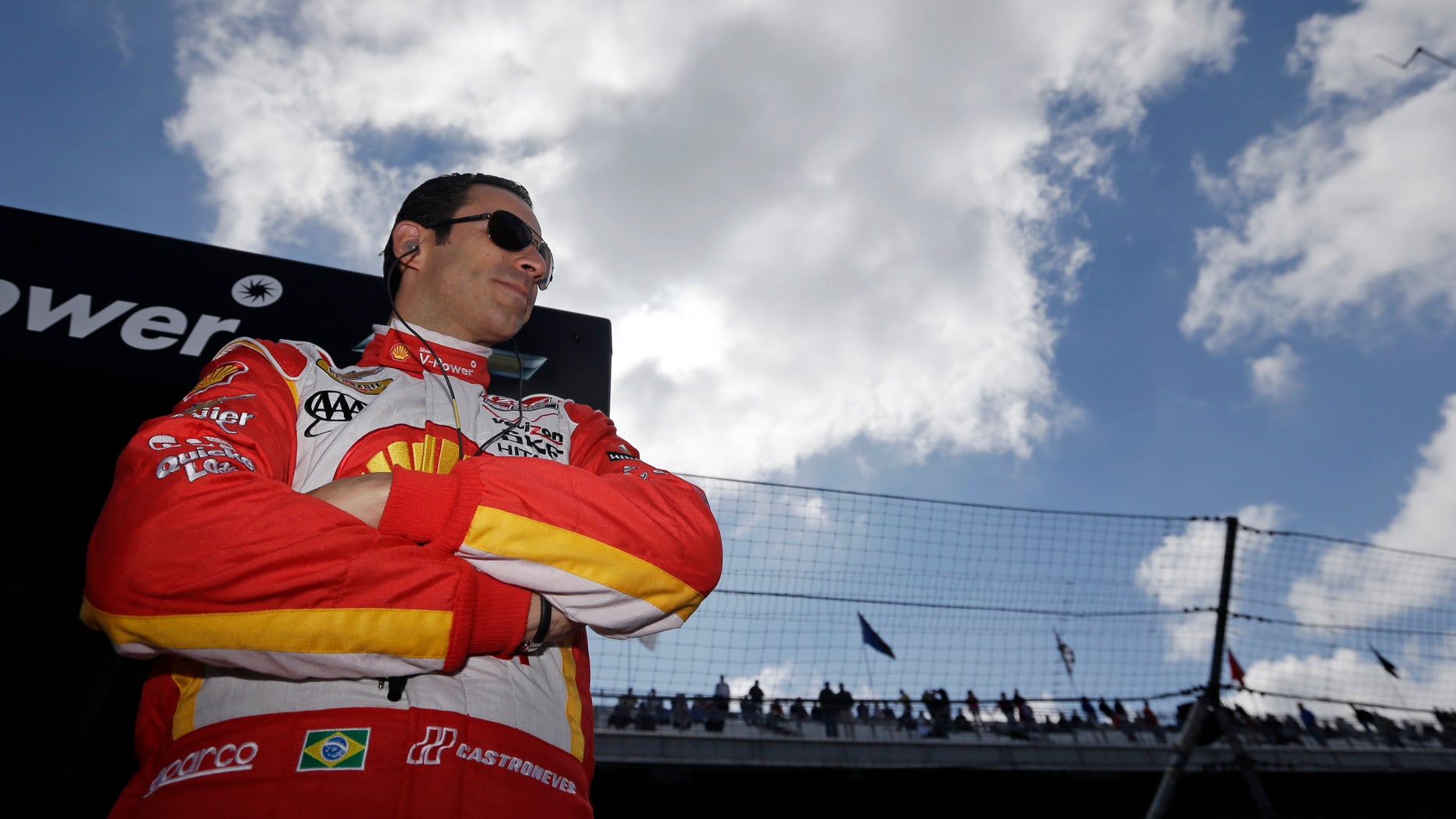 IndyCar driver Helio Castroneves, of Brazil, stands in his team pit box as he waits for the start of the final practice session for the Indianapolis 500 auto race at the Indianapolis Motor Speedway in Indianapolis, Friday, May 24, 2013. (AP Photo/Darron Cummings)