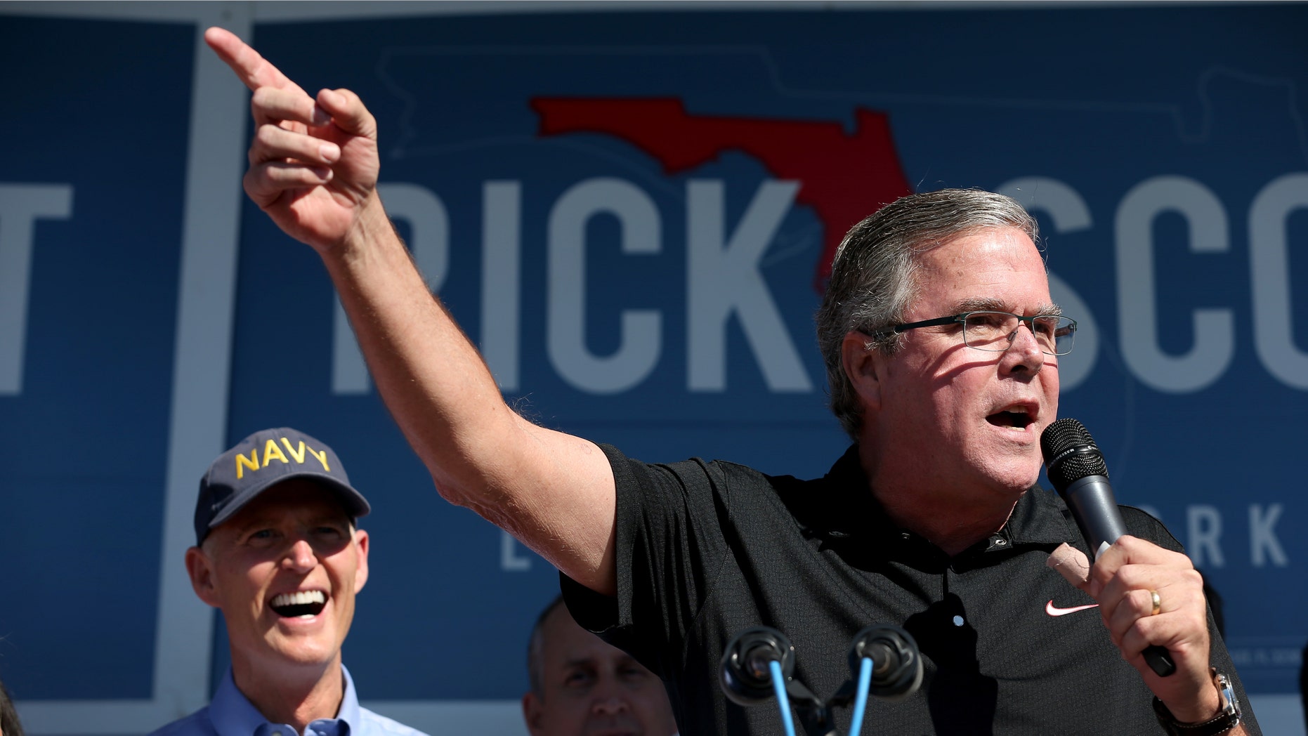HIALEAH, FL - NOVEMBER 02: Former Florida Governor Jeb Bush (R) speaks to voters as he campaigns with Florida Governor Rick Scott (L) during a campaign stop at Milander Park on November 2, 2014 in Hialeah, Florida. Republican Governor Rick Scott is running against former Florida Governor Charlie Crist in the November 4, 2014 election. (Photo by Joe Raedle/Getty Images)