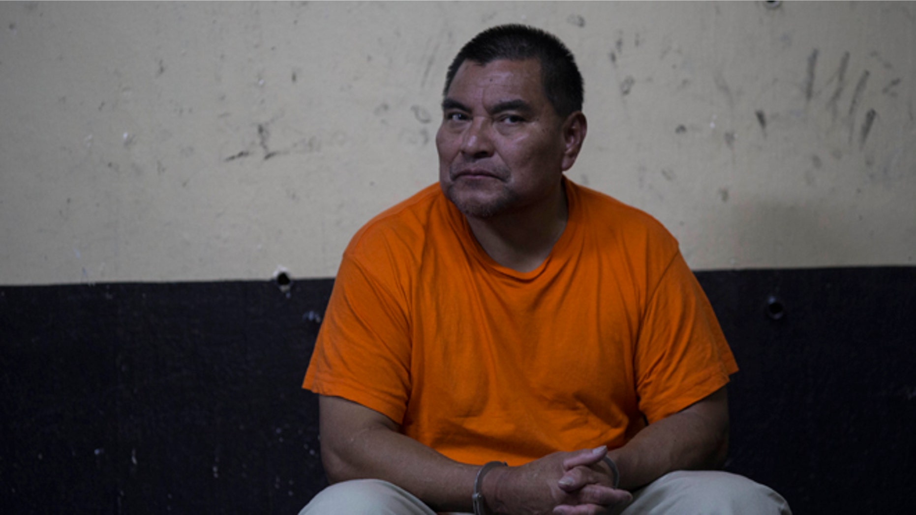 Santos Lopez Alonzo sits in a courtroom as he waits for his first hearing in Guatemala City, Wednesday, Aug. 10, 2016. Lopez Alonzo, former Guatemalan soldier suspected of helping carry out a massacre of more than 160 people in 1982 during the country's civil war was deported from the United States on Wednesday after a court refused his plea to stay because he fears for his life. (AP Photo/Luis Soto)