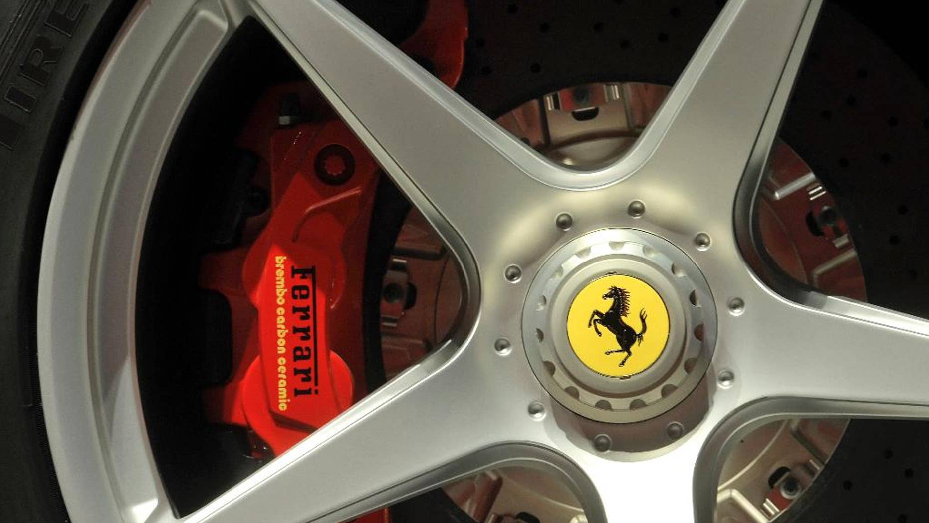 FILE - In this May 8, 2013 file photo a Ferrari logo is displayed on a wheel at the Ferrari factory in Maranello, Italy. Luxury Italian sports carmaker Ferrari has announced a record first quarter as sales of its V12 models boosted profits by 60 percent. (AP Photo/Marco Vasini, files)