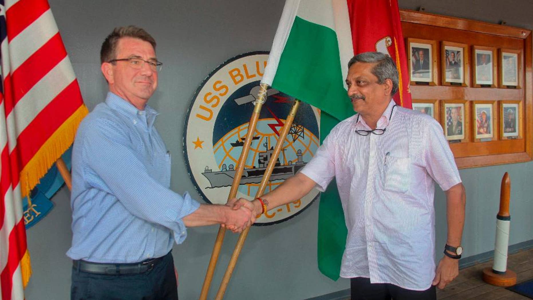 Indian Defence Minister Manohar Parrikar, right, greets US Defense Secretary Ashton Carter during his visit to the Indian Naval Base in Karwar, Karnataka state, India, Monday, April 11, 2016.(Press Trust of India via AP)INDIA OUT