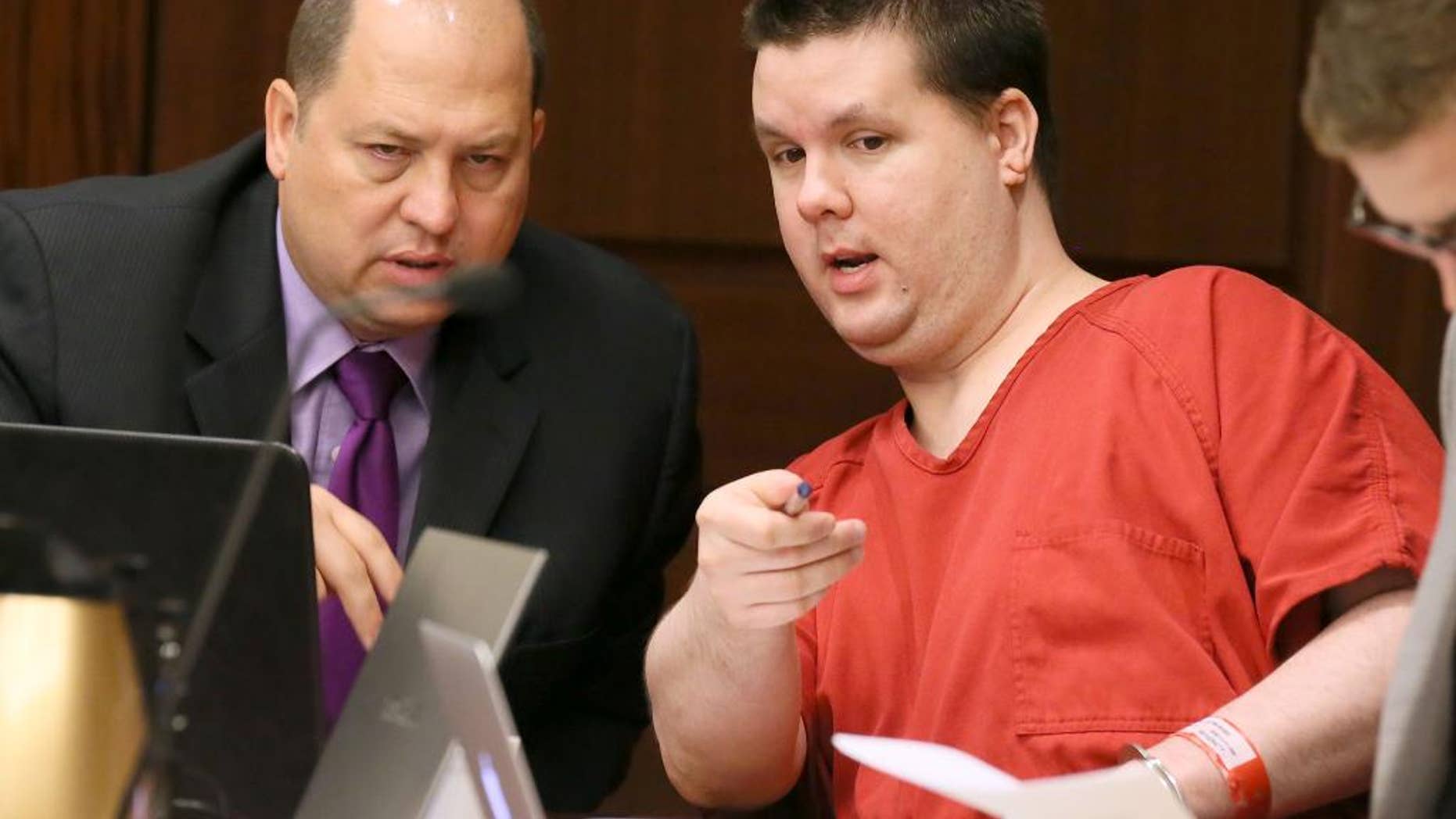 FILE - In this Sept. 15, 2015 file photo, Justin Ross Harris, right, motions to a image on a laptop on the defendant’s tables to one of his attorneys, T. Bryan Limpkin, as the pre-trial motion hearings continue in Marietta, Ga. The trial for Harris, accused of intentionally leaving his toddler son in a hot SUV to die is set to begin Monday, April 11, 2016. Harris is accused of leaving 22-month-old Cooper to die in June 2014. He's been held without bond since then on multiple charges, including murder. His attorneys have called the death a tragic accident. (Kelly J. Huff/Marietta Daily Journal via AP, Pool)