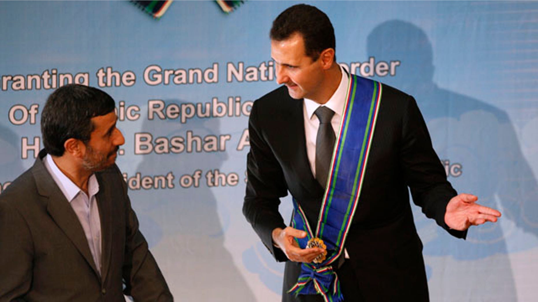 Oct. 2: Syrian President Bashar Assad, right, gestures, after he is awarded with Iran's highest national medal by his Iranian counterpart Mahmoud Ahmadinejad, in Tehran, Iran. Assad has overlooked the White House's efforts to improve relations in favor of alliances with Iran and militant groups such as Hezbollah and the Palestinian Hamas.
