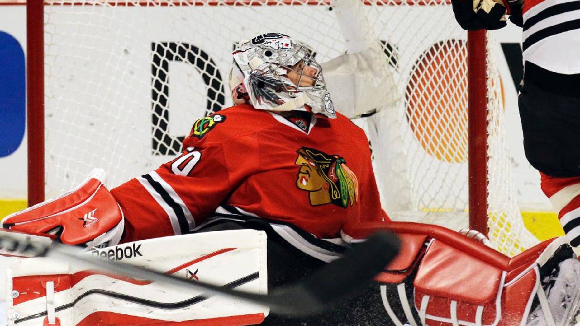 Chicago Blackhawks goalie Corey Crawford (50) reacts after Minnesota Wild's Erik Haula (56) scored his goal during the first period in Game 5 of an NHL hockey second-round playoff series in Chicago,Sunday, May 11, 2014. (AP Photo/Nam Y. Huh)
