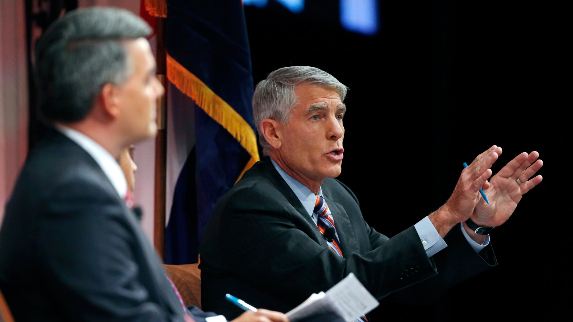 Incumbent U.S. Sen. Mark Udall, right, during a debate with U.S. Rep. Cory Gardner in Denver, on Oct. 6, 2014.