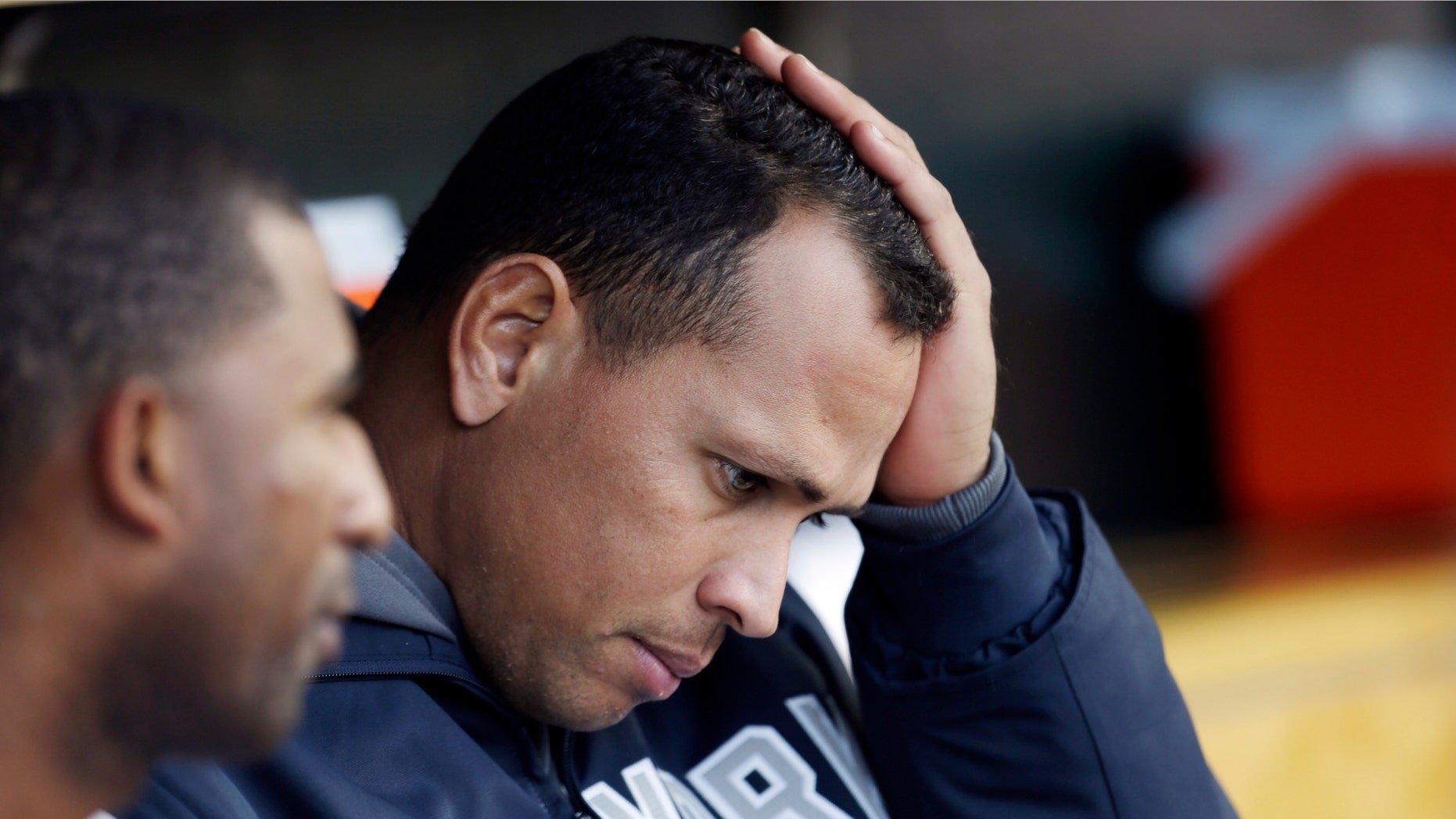 FILE - In this Oct. 18, 2012, file photo, New York Yankees' Alex Rodriguez watches from the dugout during Game 4 of the American League championship series against the Detroit Tigers in Detroit. Yankees general manager Brian Cashman says it's possible that third baseman Alex Rodriguez could miss the entire season while coming off hip surgery. He made his remarks Friday on WFAN radio in New York. (AP Photo/Paul Sancya, File)