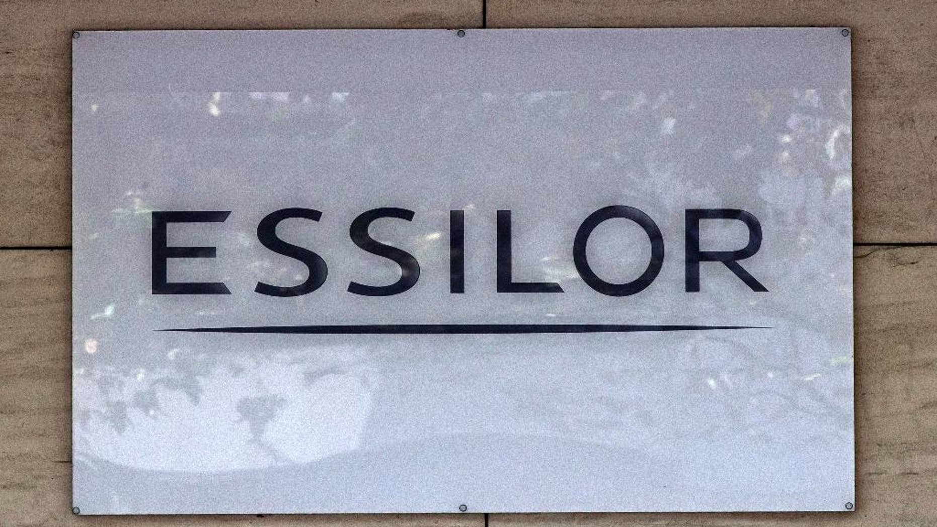 This Thursday, Sept. 22, 2016 photo shows the logo of the Essilor a French ophthalmic optics company, in Charenton le Pont, east of Paris. Essilor International SA announced Monday Jan.16, 2017 it had reached a share exchange deal with Luxottica's main shareholder Delfin to create a combined company making both frames and lenses. (AP Photo/Michel Euler)