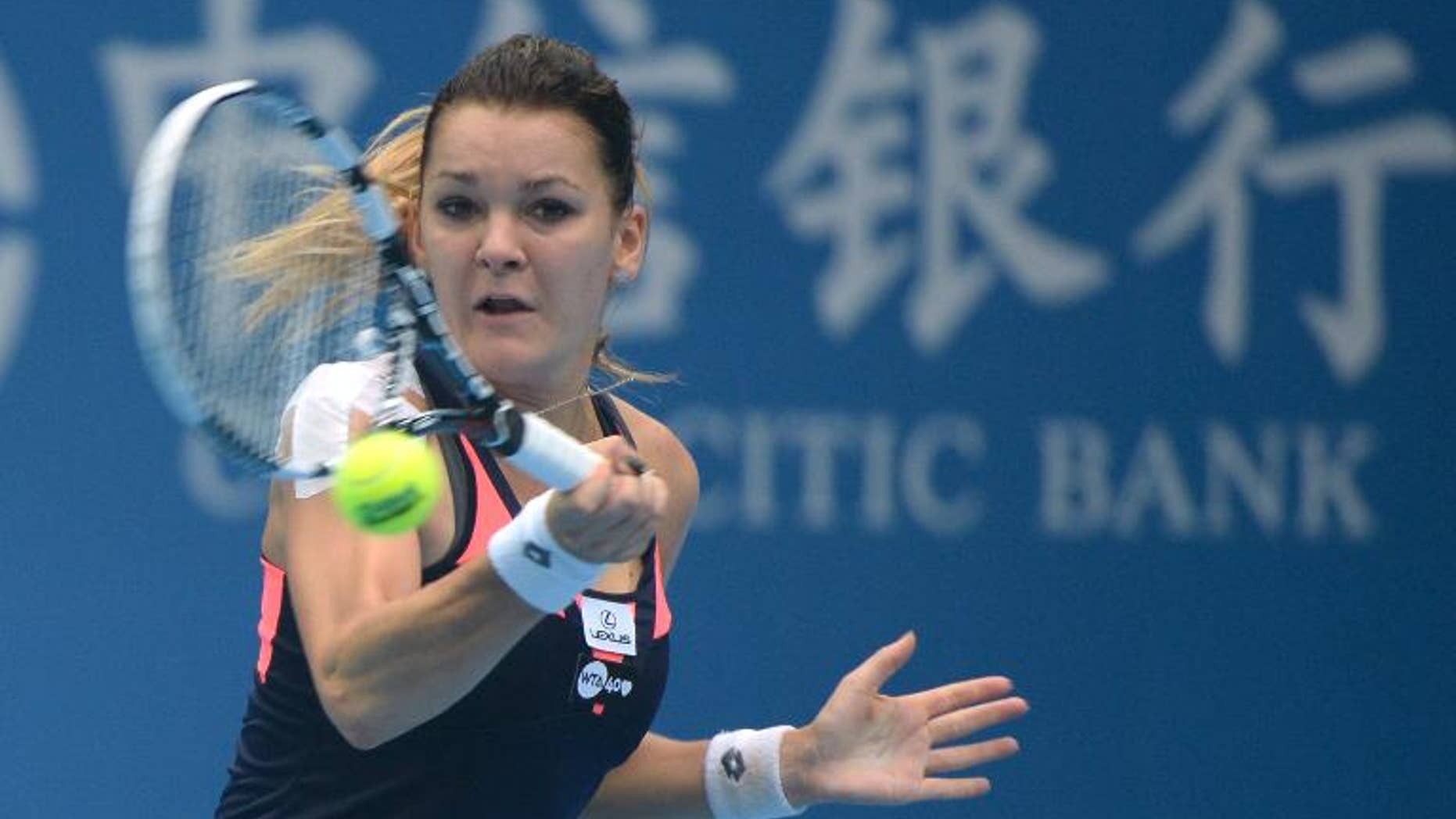 Agnieszka Radwanska of Poland returns to Stefanie Voegele of Switzerland during their women's single match at the China Open tennis tournament in Beijing on September 29, 2013
