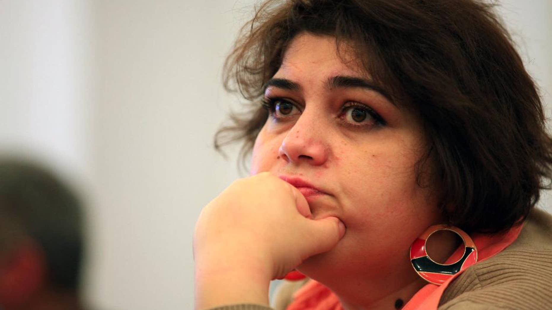 This photo taken Sunday, March 2, 2014, shows Azerbaijani Khadija Ismayilova, a reporter for Radio Free Europe/Radio Liberty, in Baku, Azerbaijan. Azerbaijan detained Khadija Ismayilova, a prominent investigative journalist, on Friday whose reporting has often featured the business dealings of top politicians in the country. (AP Photo/Aziz Karimov)
