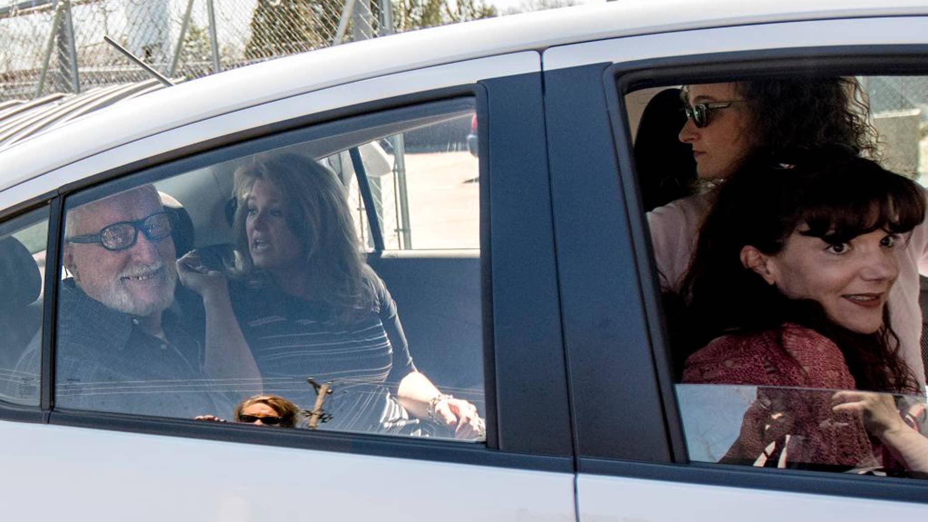 Jack McCullough, left, smiles from the backseat of his stepdaughter Janey O'Connor's rental car after he was released from the DeKalb County Jail in Sycamore, Ill., Friday, April 15, 2016. An Illinois judge vacated the conviction of the 76-year-old man in a 1957 killing and ordered his immediate release from prison Friday, meaning that one of the oldest cold cases to be tried in U.S. history has officially gone cold again. (Danielle Guerra/Daily Chronicle via AP) MANDATORY CREDIT; CHICAGO TRIBUNE OUT