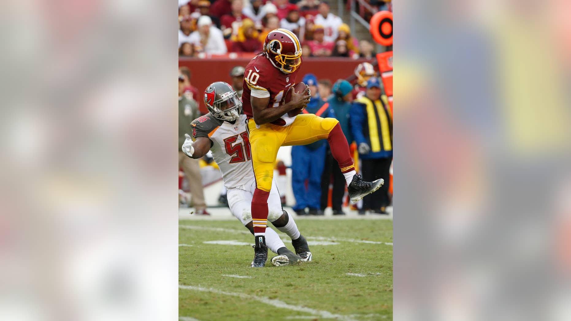 Tampa Bay Buccaneers defensive end Jacquies Smith (56) sacks Washington Redskins quarterback Robert Griffin III (10) during the second half of an NFL football game in Landover, Md., Sunday, Nov. 16, 2014. The Buccaneers defeated the Redskins 27-7. (AP Photo/Alex Brandon)