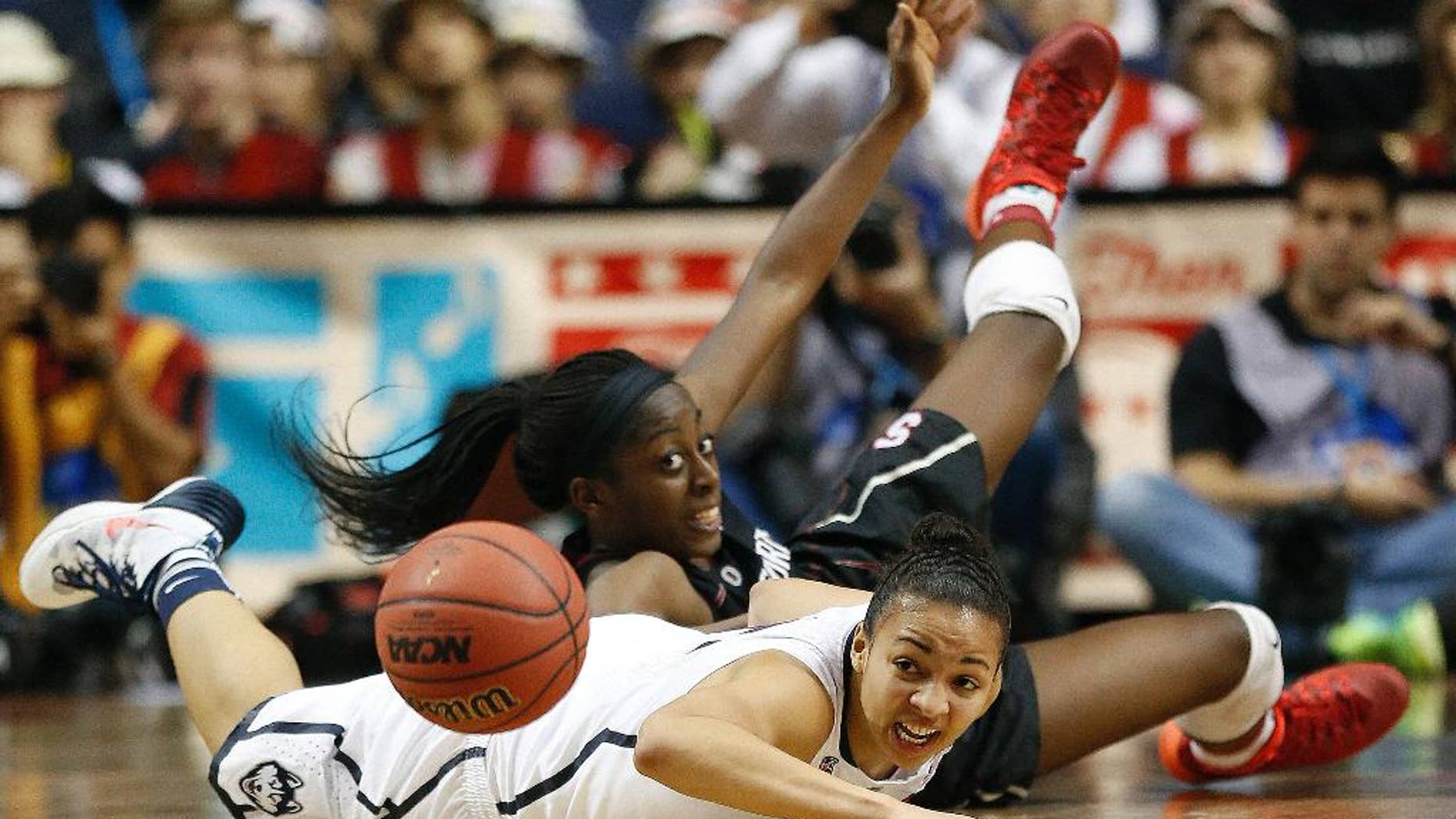 Stanford forward Chiney Ogwumike (13) and Connecticut guard Bria Hartley (14) collide during the second half of the semifinal game in the Final Four of the NCAA women's college basketball tournament, Sunday, April 6, 2014, in Nashville, Tenn. Connecticut won 75-56. (AP Photo/John Bazemore)