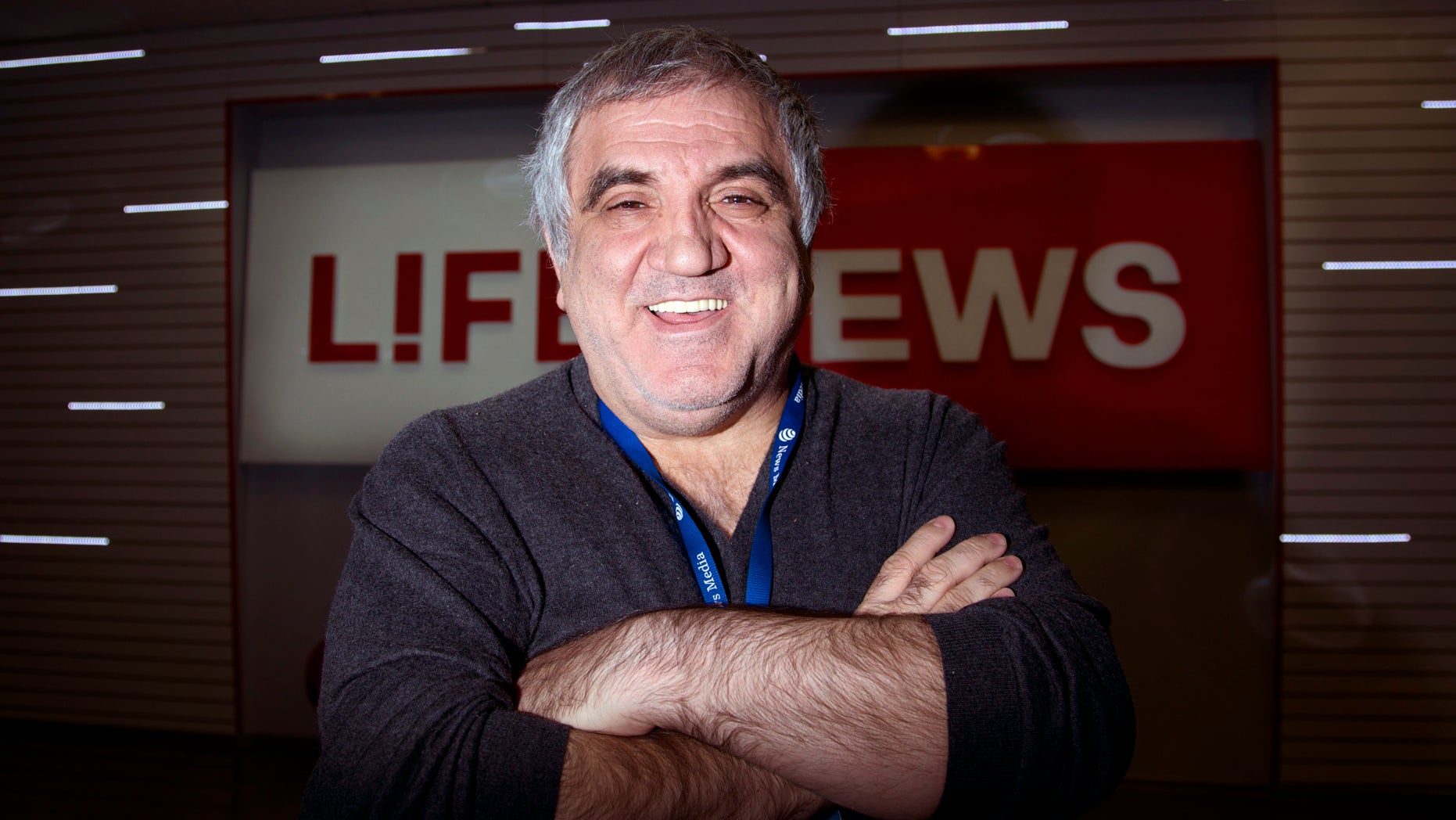 Aram Gabrelyanov, Lifenews owner, smiles during the interview to The Associated Press in the company headquarters in Moscow on Monday, Oct. 14, 2013. Now the Gabrelyanovs’ company, News Media Holding, earns $1.5 billion per year. In addition to Life, they own Izvestia, once the official newspaper of the Soviet government, as well as two tabloids and three websites. The younger son and inheritor of the empire, 24-year-old Ashot, runs Lifenews.ru as well as a new TV station. There is no substantive division between the holding’s publications, which freely feed one another information and scoops, which are then retailored for each audience. The elder son, 26-year-old Artem, directs their comic book line, with a host of Russified superheroes that includes an Orthodox priest. (AP Photo/Ivan Sekretarev)