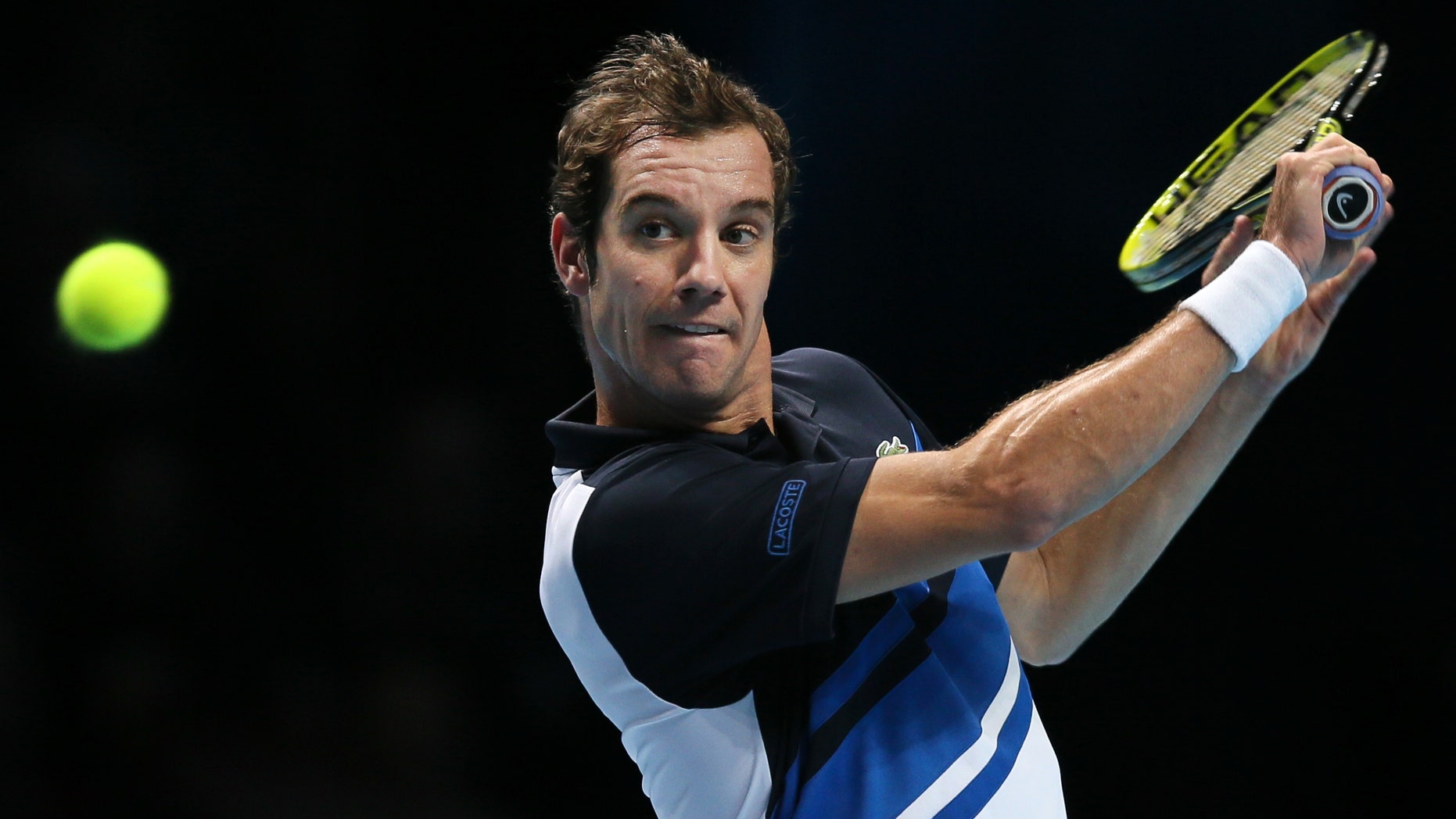 Richard Gasquet of France plays a return to Novak Djokovic of Serbia during their ATP World Tour Finals tennis match at the O2 Arena in London, Saturday, Nov. 9, 2013. (AP Photo/Alastair Grant)