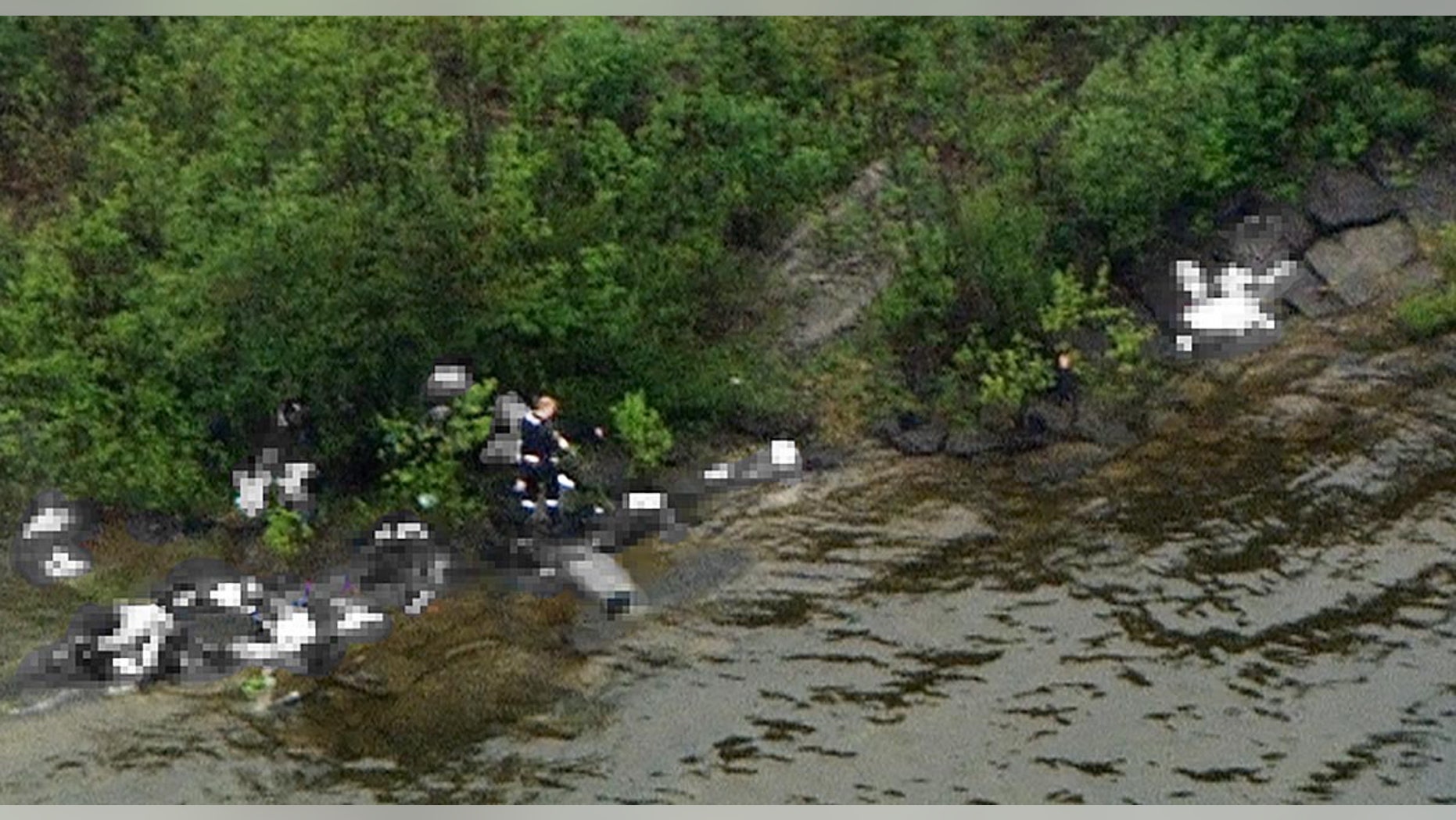 July 22: This photo taken from a helicopter above Utoya island near Oslo, Norway, shows what police believe is the alleged gunman walking among victims after opening fire on a youth retreat.