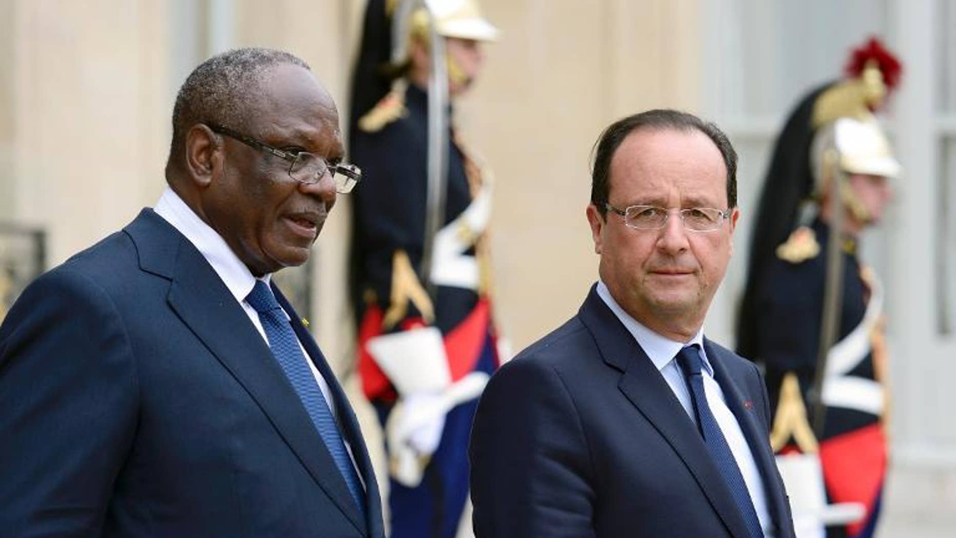 France President Francois Hollande (right) accompanies his Malian counterpart Ibrahim Boubacar at the Elysee palace in Paris on October 1st, 2013