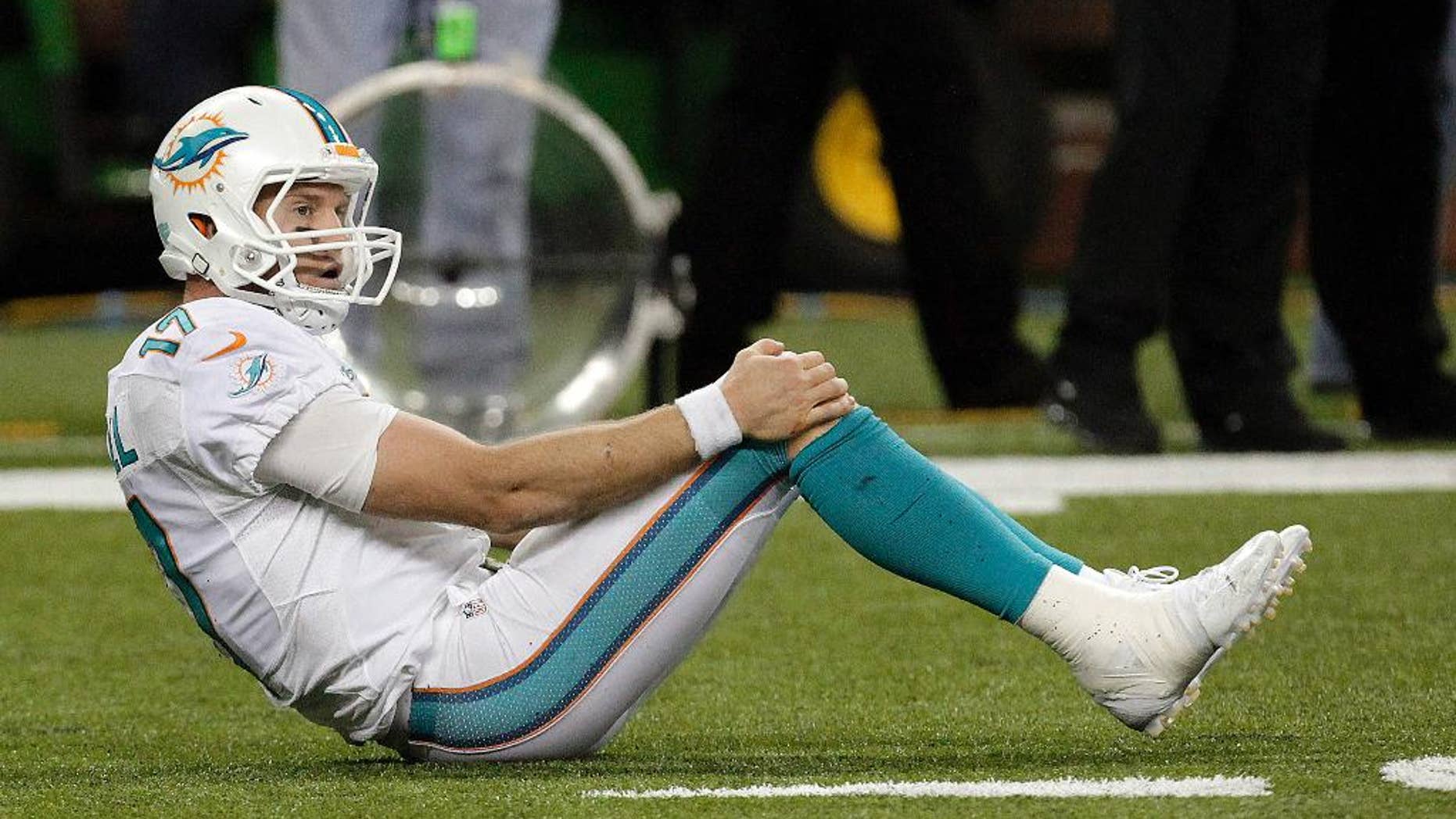 Miami Dolphins quarterback Ryan Tannehill rights himself after the final play in the fourth quarter of an NFL football game against the Detroit Lions in Detroit, Sunday, Nov. 9, 2014. Detroit won 20-16. (AP Photo/Paul Sancya)