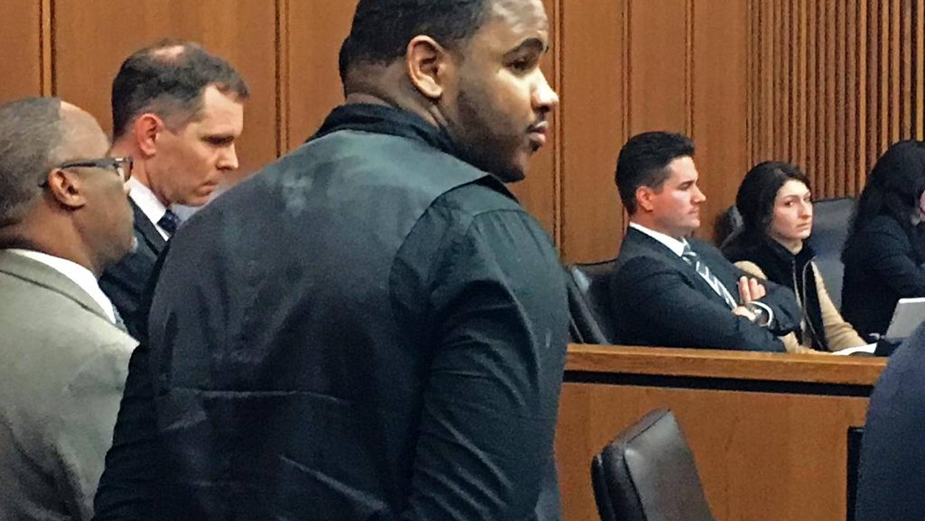 Douglas Shine Jr., front center, stands with attorneys as a verdict is read in his trial Friday, Nov. 4, 2016, at the Cuyahoga County Justice Center in Cleveland. Shine, accused of killing three people at a barbershop outside Cleveland, was found guilty on Friday of aggravated murder and other charges and could face the death penalty. (AP Photo/Mark Gillispie)
