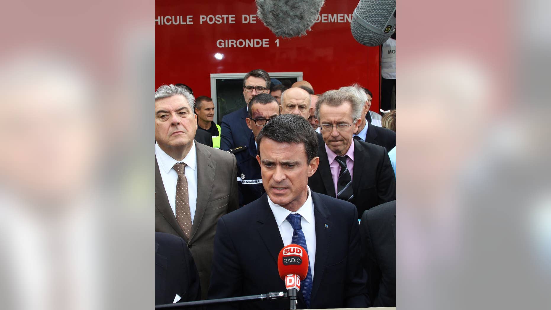 French Prime Minister Manuel Valls addresses the media in Puisseguin, near Bordeaux, southwestern France, following a road accident in which at least 42 people were killed, Friday, Oct. 23, 2015. French Prime Minister Manuel Valls says a bus and truck collision in southwest wine country that killed 42 was the deadliest road accident in France in more than 30 years. (AP Photo/Bod Edme)