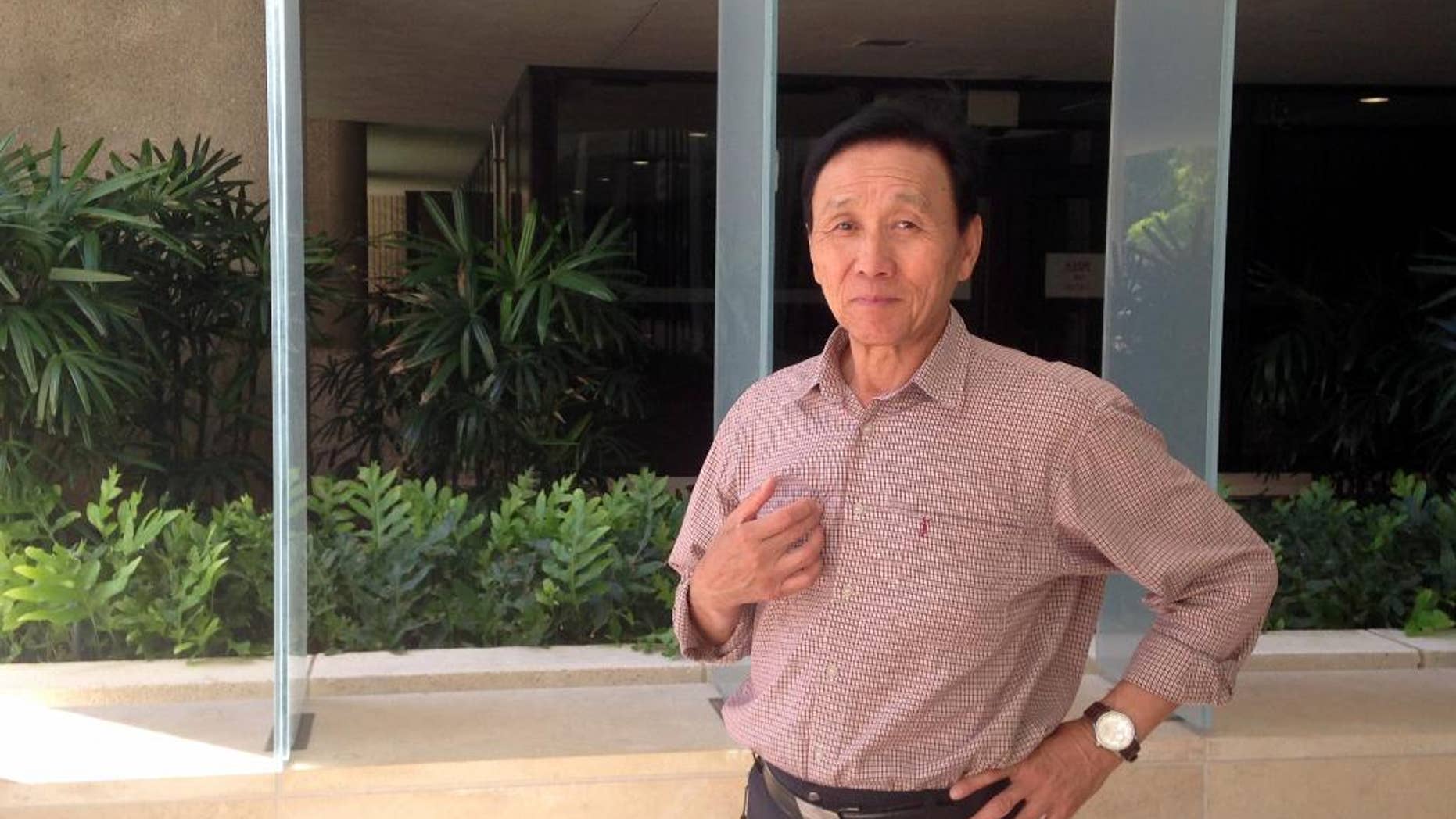 FILE - In this Thursday, April 21, 2016 file photo, Hyongtae Pae stands outside the federal courthouse in Honolulu, after pleading guilty to interfering with a flight crew. Pae, a Korean tourist who was arrested after he became violent when he wasn't allowed to do yoga on a plane leaving Hawaii won't get additional jail time. But he must pay United Airlines more than $44,000. A federal judge in Honolulu on Thursday, July 28, 2016, sentenced Pae to time served, which was about 13 days. He'll be under court supervision for three years, which is the amount of time he has to pay the restitution. (AP Photo/Jennifer Sinco Kelleher, File)