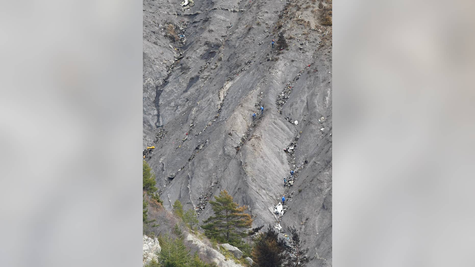 Rescue workers work at the crash site near Seyne-les-Alpes, France, Monday, March 30, 2015. European investigators are focusing on the psychological state of a 27-year-old German co-pilot who prosecutors say deliberately flew a Germanwings plane carrying 150 people into a mountain, a French police official said Monday. (AP Photo/Claude Paris, Pool)
