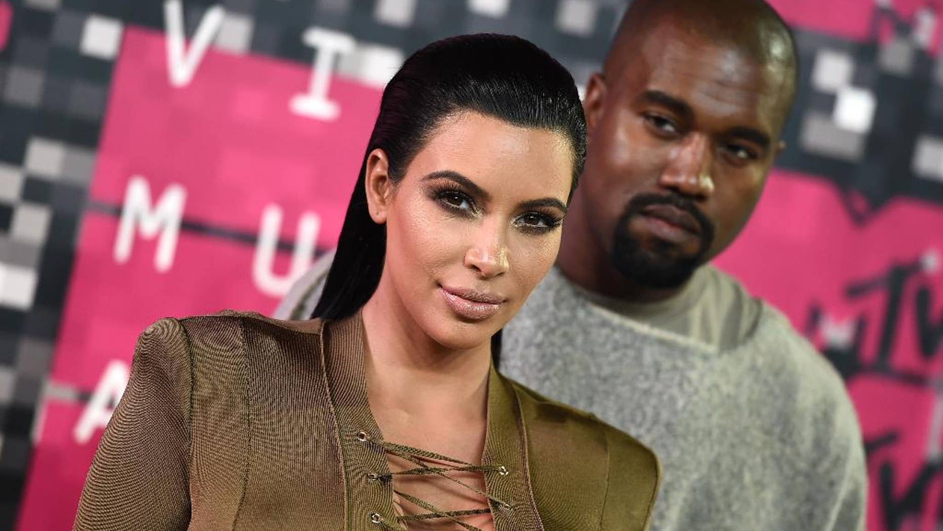 FILE - In this Aug. 30, 2015, file photo, Kim Kardashian, left, and Kanye West arrive at the MTV Video Music Awards at the Microsoft Theater in Los Angeles. Kardashian praised her husband's May 19, 2016, appearance on "The Ellen DeGeneres Show" on Twitter. (Photo by Jordan Strauss/Invision/AP, File)