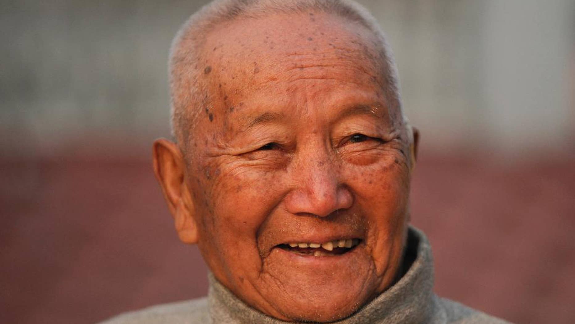 Nepalese mountain climber Min Bahadur Sherchan, 85, smiles after his morning yoga workout at home in Kathmandu, Nepal, last month.