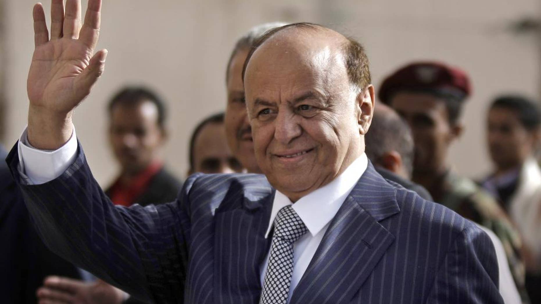 FILE - In this Tuesday, Feb. 21, 2012 file photo,Yemen's Vice President Abed Rabbo Mansour Hadi gestures as he enters a polling center to cast his vote in Sanaa. Yemen's embattled president fled his palace in Aden for an undisclosed location Wednesday as Shiite rebels offered cash bounty for his capture and arrested his defense minister. Hadi left just hours after the rebels' own television station said they seized an air base where U.S. troops and Europeans advised the country in its fight against al-Qaida militants. (AP Photo/Hani Mohammed, File)