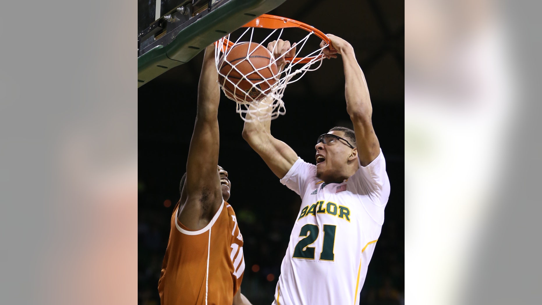 Baylor's Isaiah Austin (21) scores over Texas' Jonathan Holmes during the second half of a NCAA college basketball game, Saturday, Jan. 5, 2013, in Waco, Texas. Baylor won in overtime 86-79. (AP Photo/Waco Tribune Herald, Rod Aydelotte)