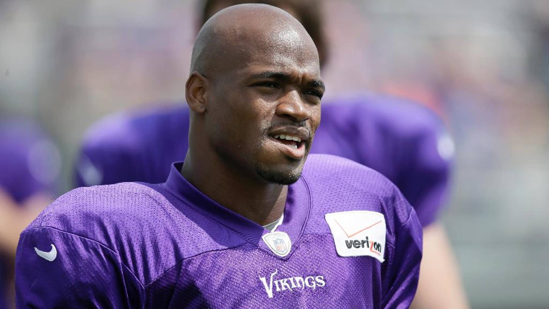 FILE - This July 31, 2014, file photo shows Minnesota Vikings running back Adrian Peterson during NFL football training camp in Mankato, Minn. The NFL suspended Adrian Peterson without pay for at least the remainder of the season. The league said Tuesday, Nov. 18, 2014, it informed the Minnesota Vikings running back he will not be considered for reinstatement before April 15 for violating the NFL personal conduct policy. (AP Photo/Charlie Neibergall, File)
