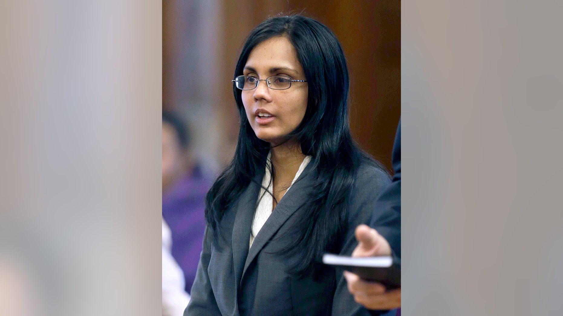 FILE - In this Jan. 9, 2013 file photo, Annie Dookhan, a former Massachusetts chemist accused of faking test results at a state drug lab, pleads not guilty during her arraignment at Superior Court, in Dedham, Mass. Dookhan is expected to appear in Suffolk Superior Court, in Boston, Friday, Oct. 18 when her lawyer and prosecutors are expected to discuss a potential guilty plea to resolve the case against her. (AP Photo/Steven Senne, Pool, File)